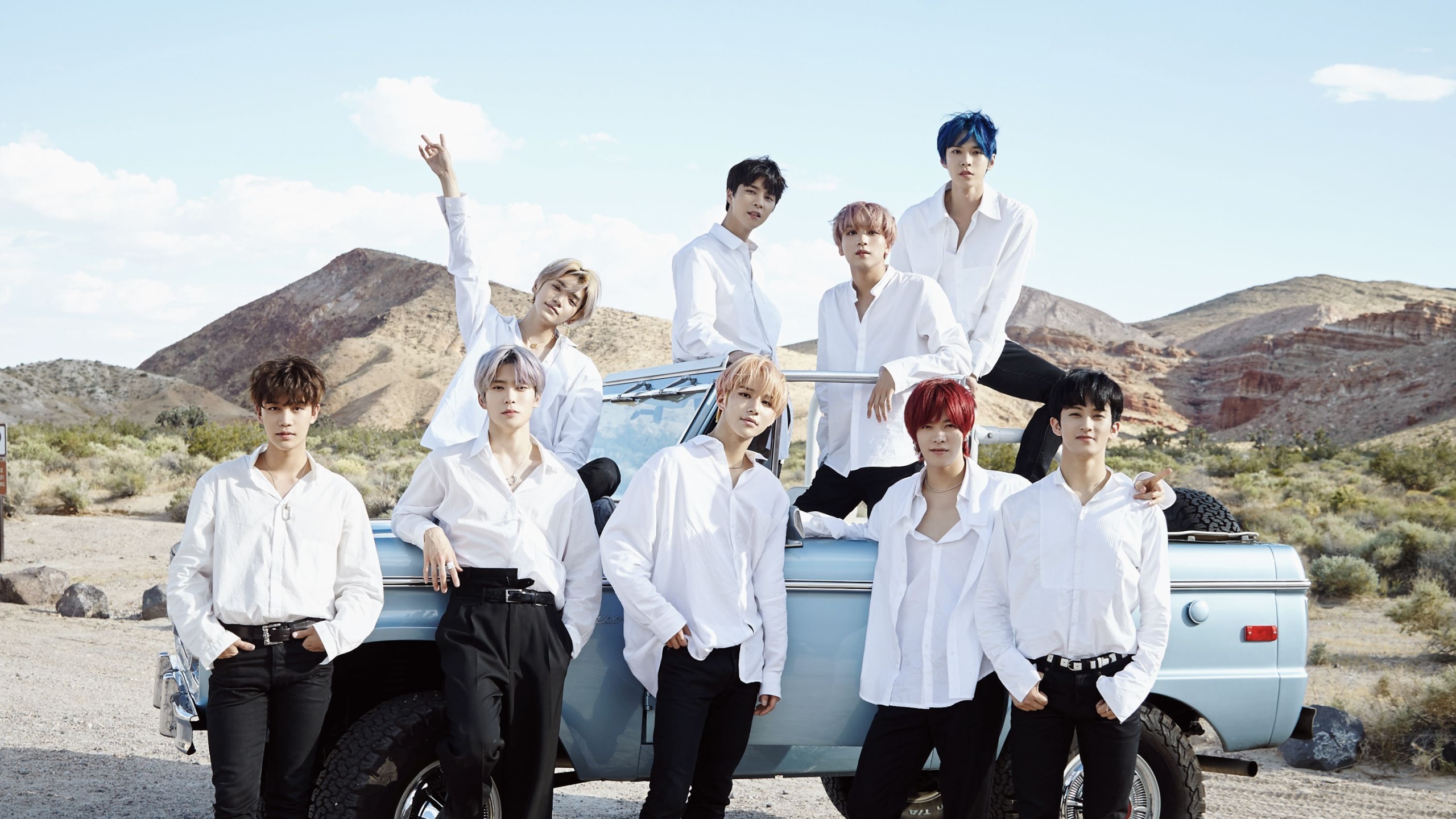 NCT members posing in desert with a vintage truck HD Wallpaper