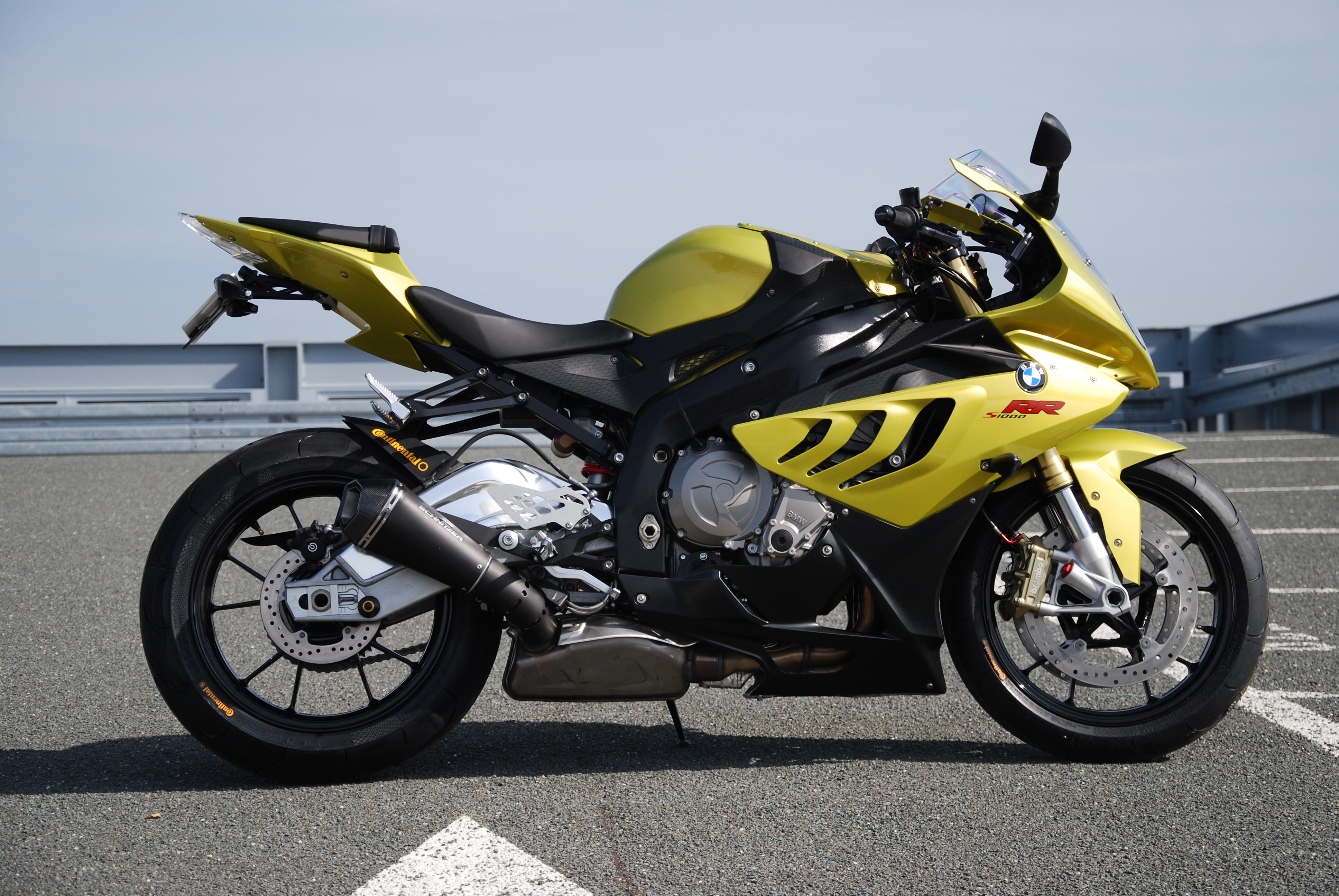 Yellow BMW S1000RR motorcycle parked outdoors HD Wallpaper