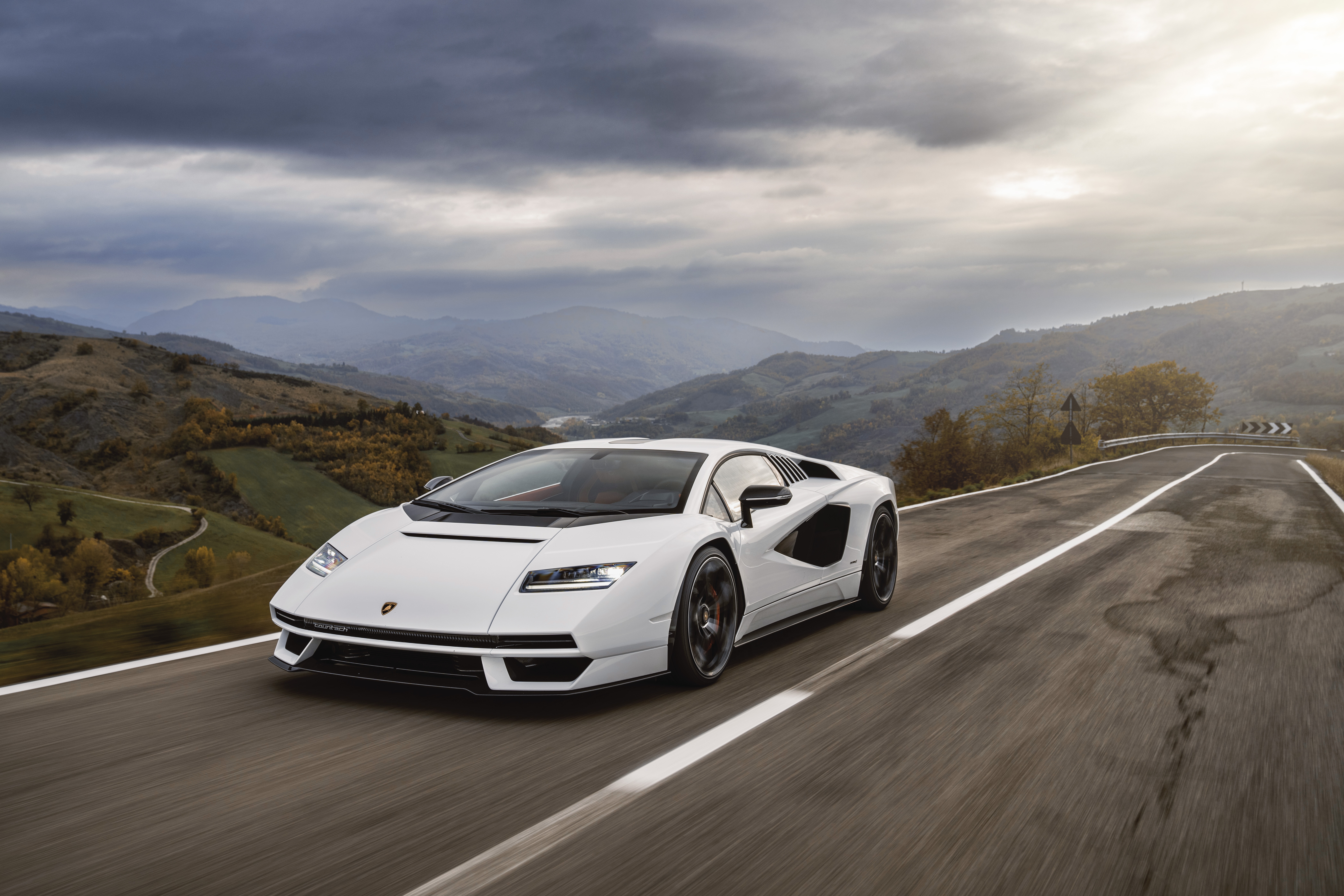 White Lamborghini Countach LPI 800-4 driving on a winding road HD Wallpaper