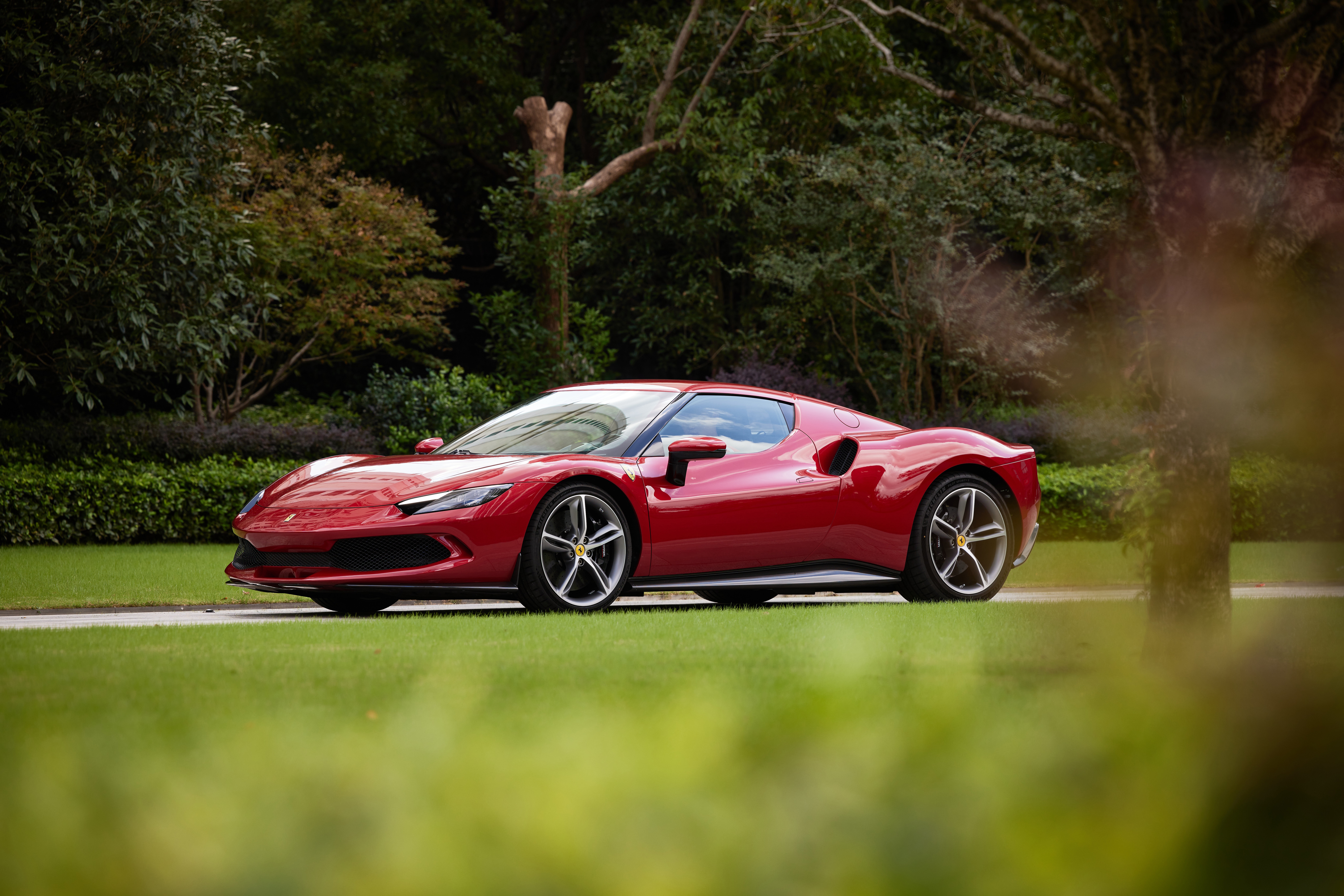 Red Ferrari 296 GTB Supercar on Grass HD Wallpaper