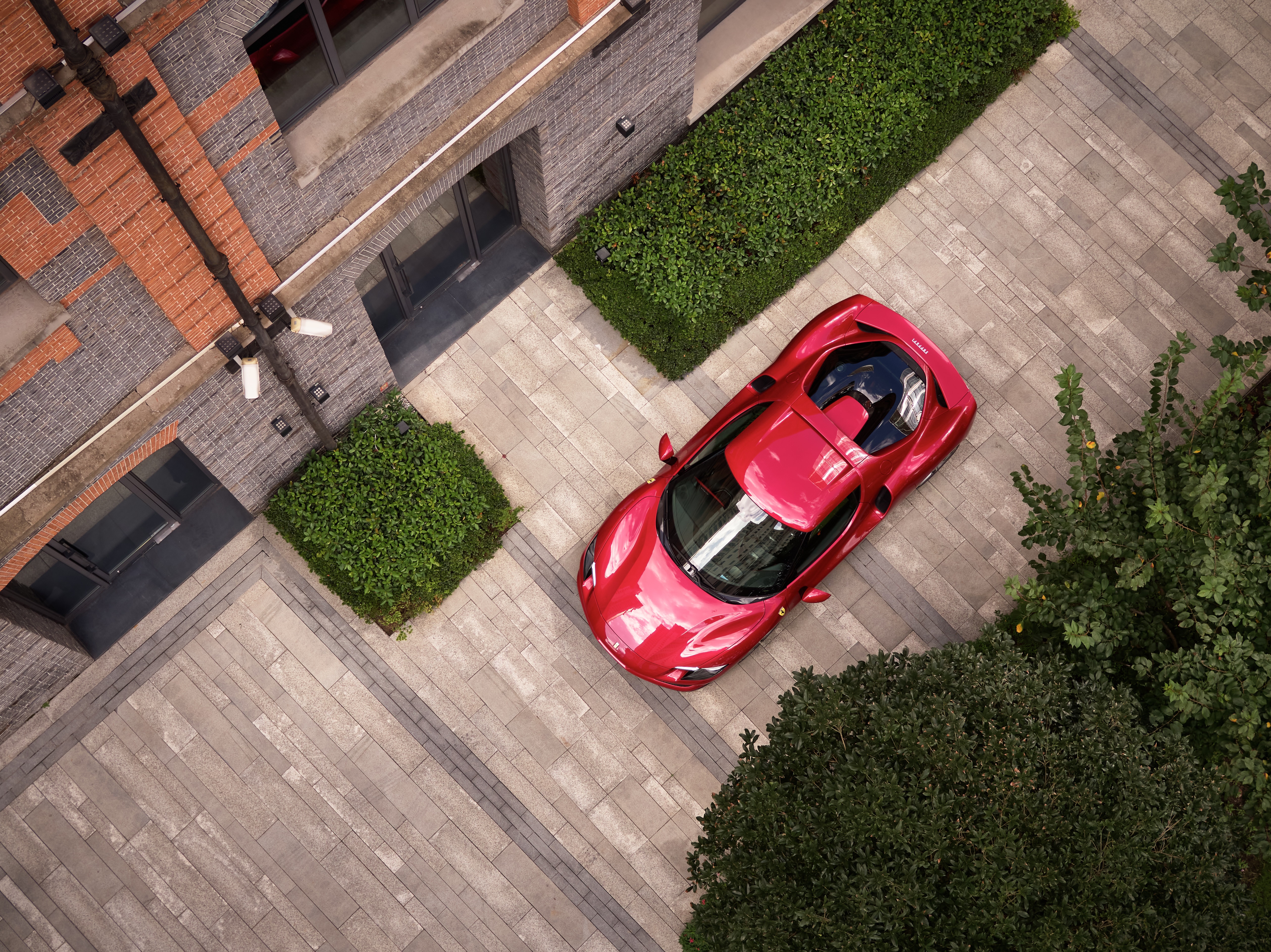 Red Ferrari 296 GTB Supercar parked near building HD Wallpaper