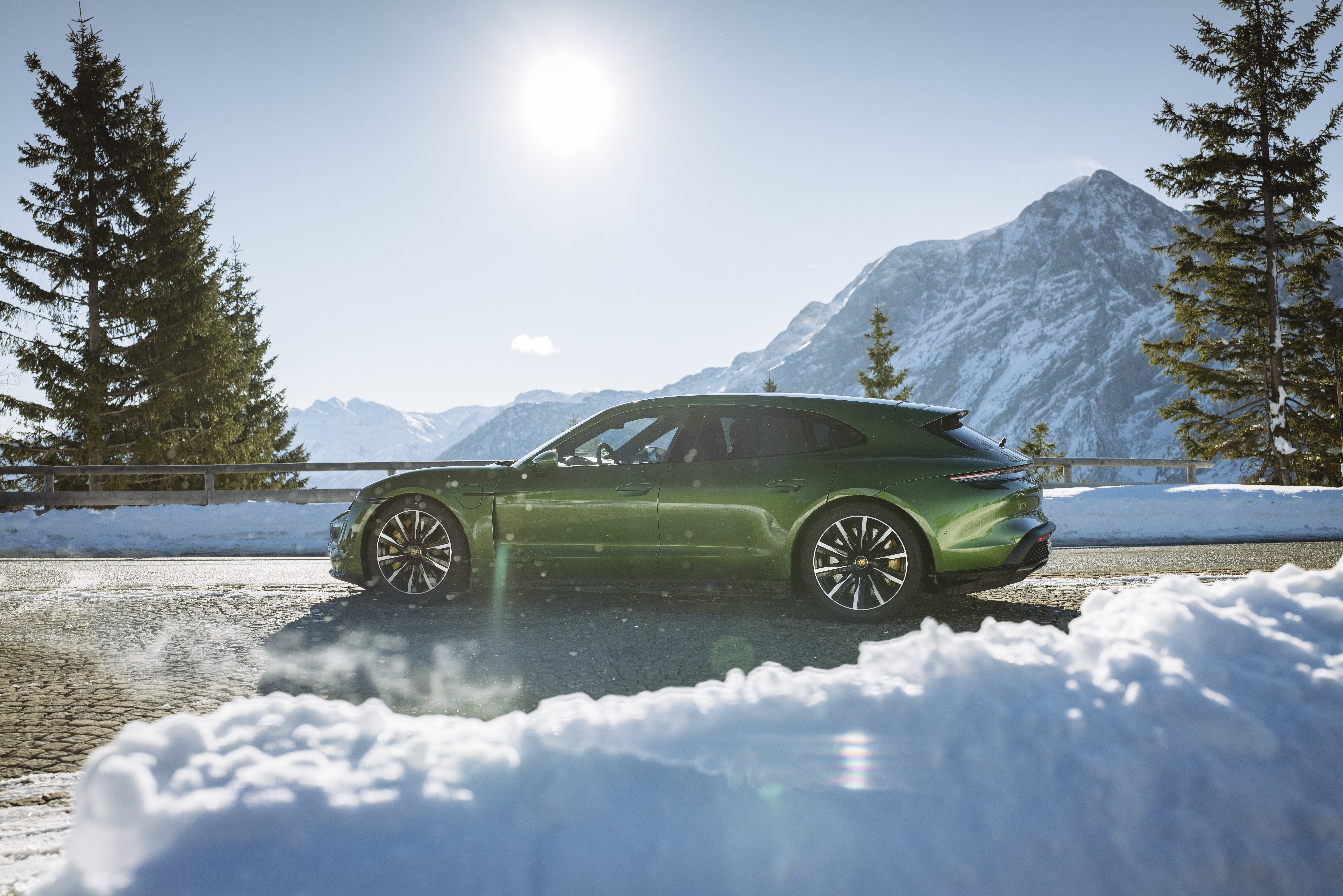 Green Porsche Taycan Turbo S in snowy mountains HD Wallpaper