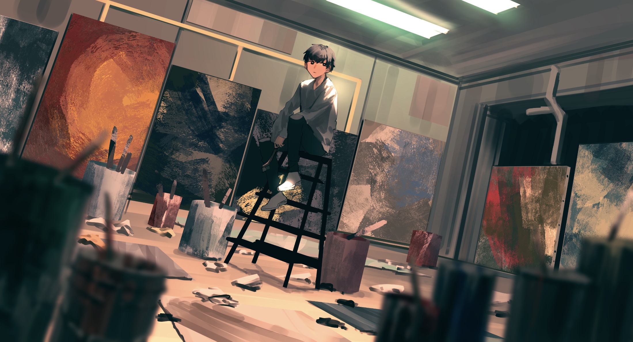 Boy in an art studio surrounded by paintings HD Wallpaper