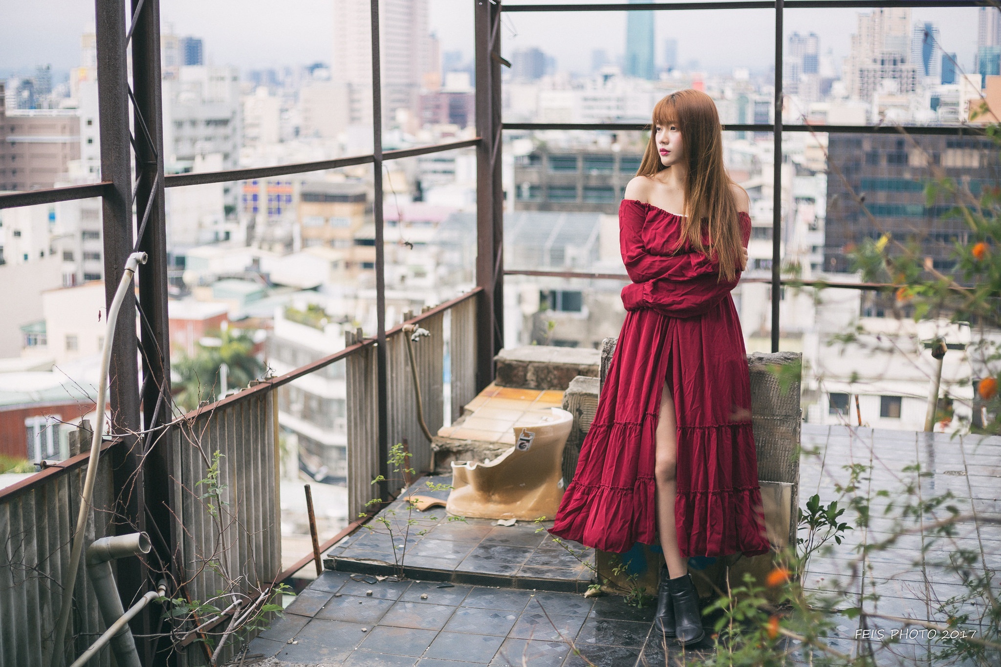 Asian woman in red dress on rooftop overlooking city HD Wallpaper
