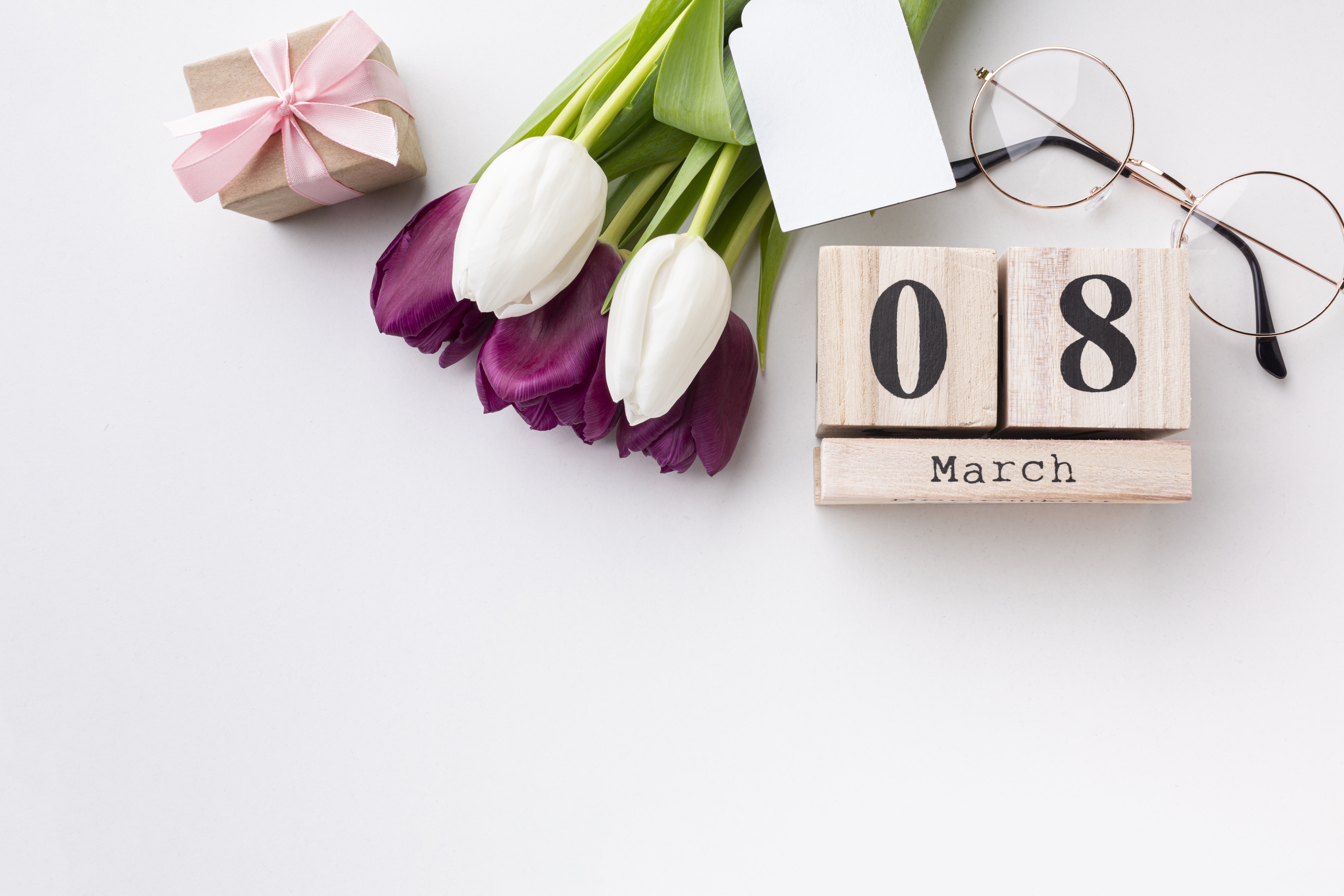 Wooden calendar showing March 8, tulips, gift, and glasses HD Wallpaper