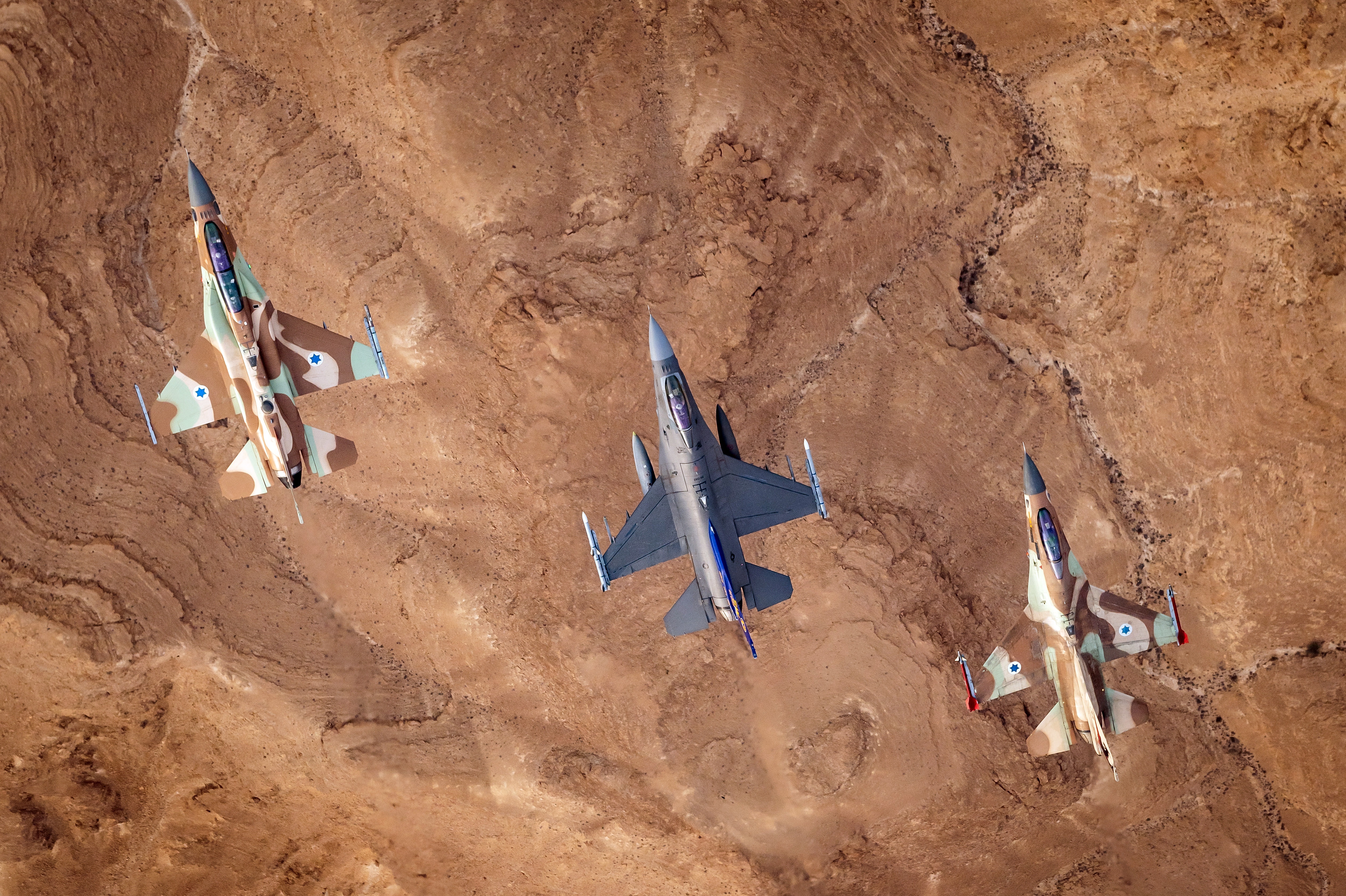 Three fighter jets flying over a desert landscape HD Wallpaper