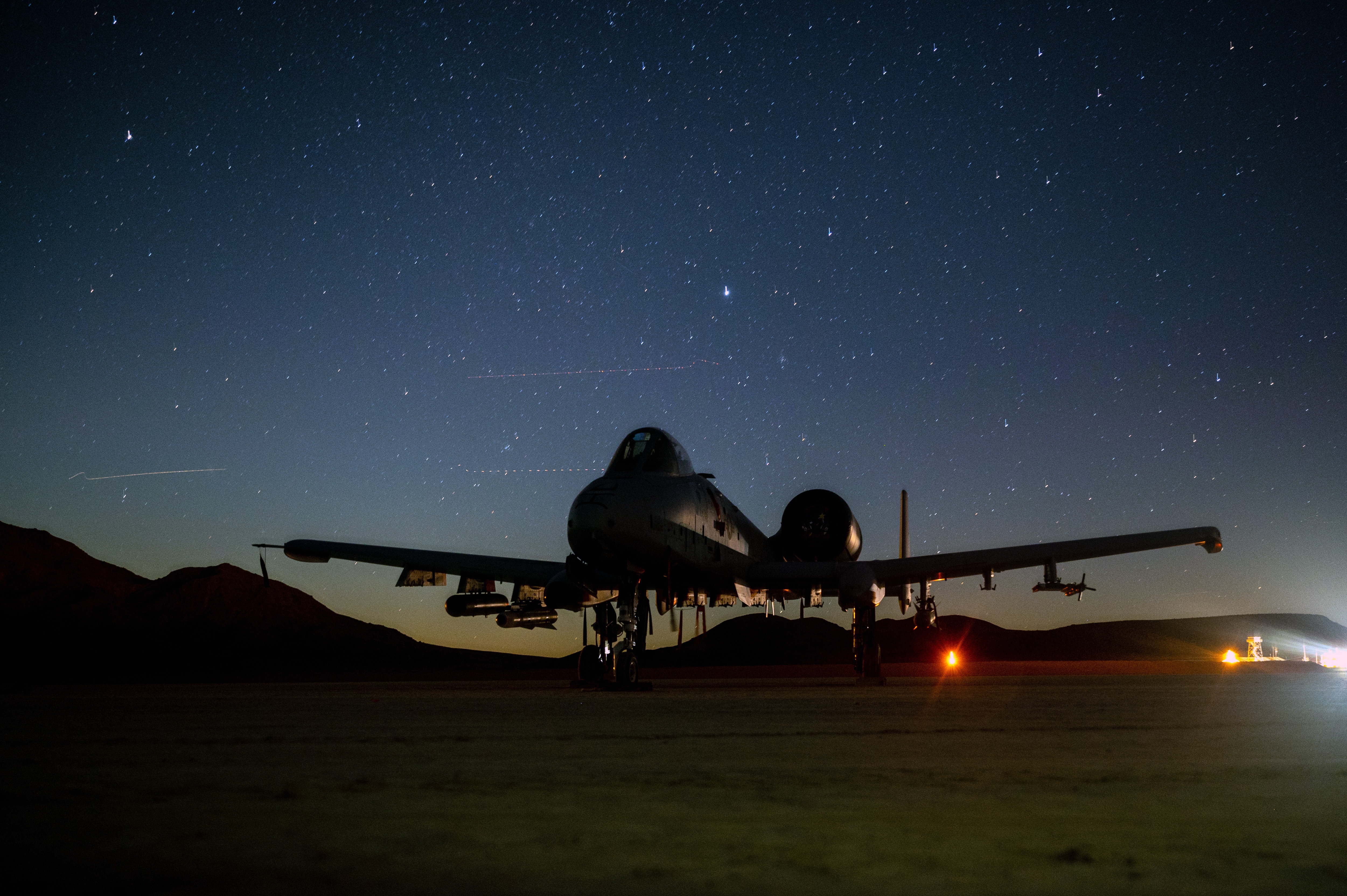 A-10 Thunderbolt II aircraft at night under stars HD Wallpaper