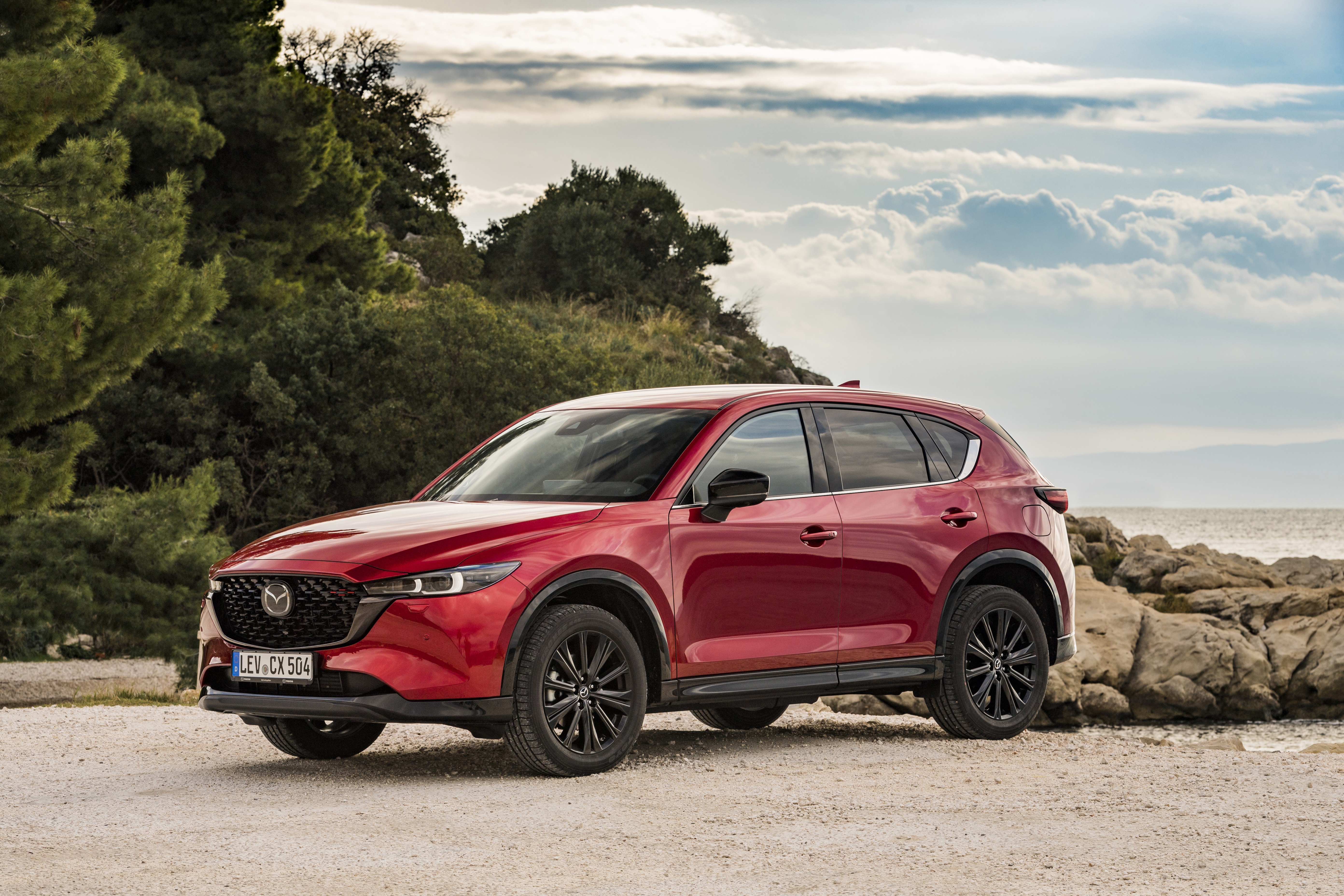 Red Mazda CX-5 SUV parked by the sea HD Wallpaper