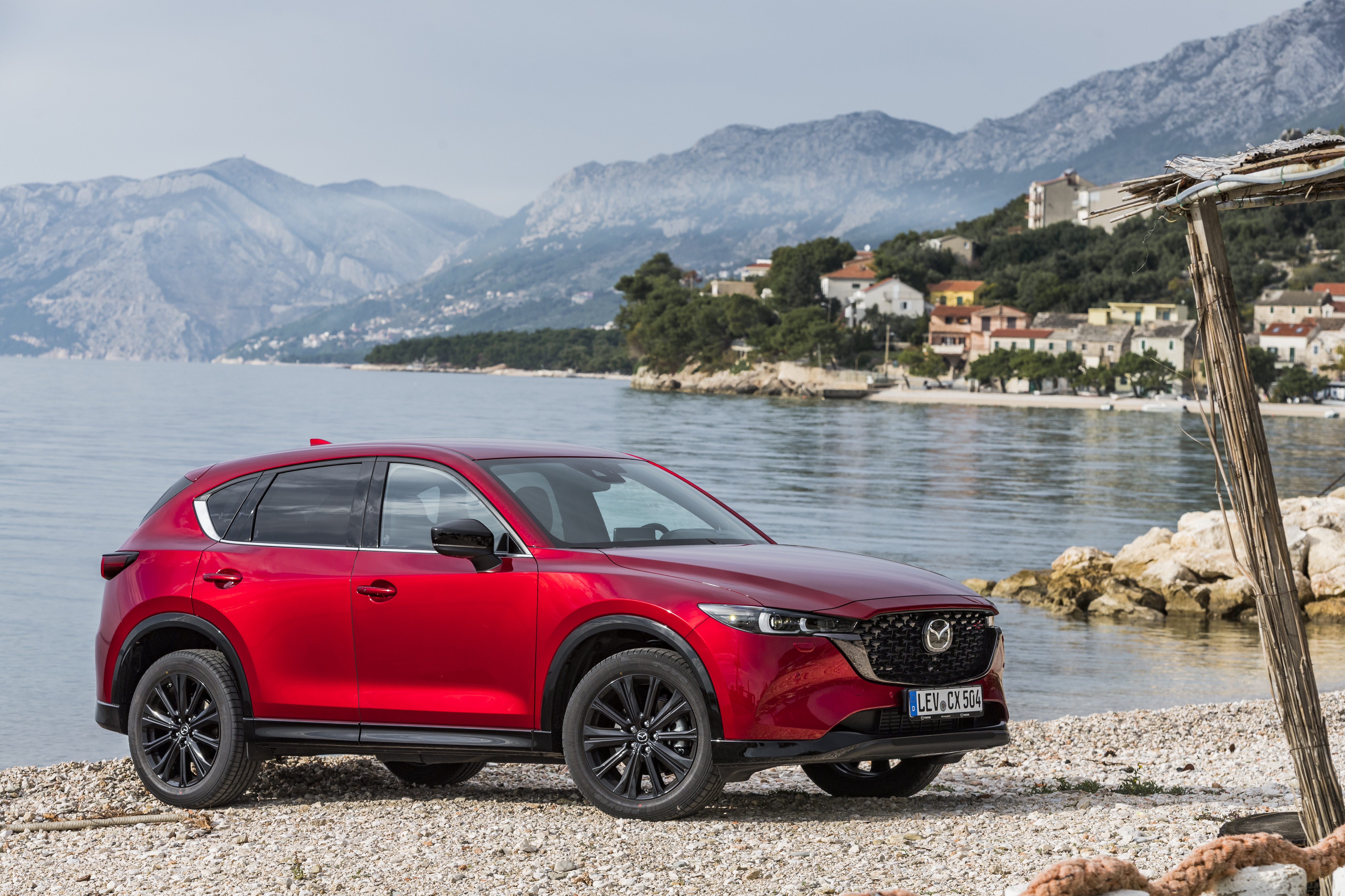 Red Mazda CX-5 SUV parked on a beach HD Wallpaper