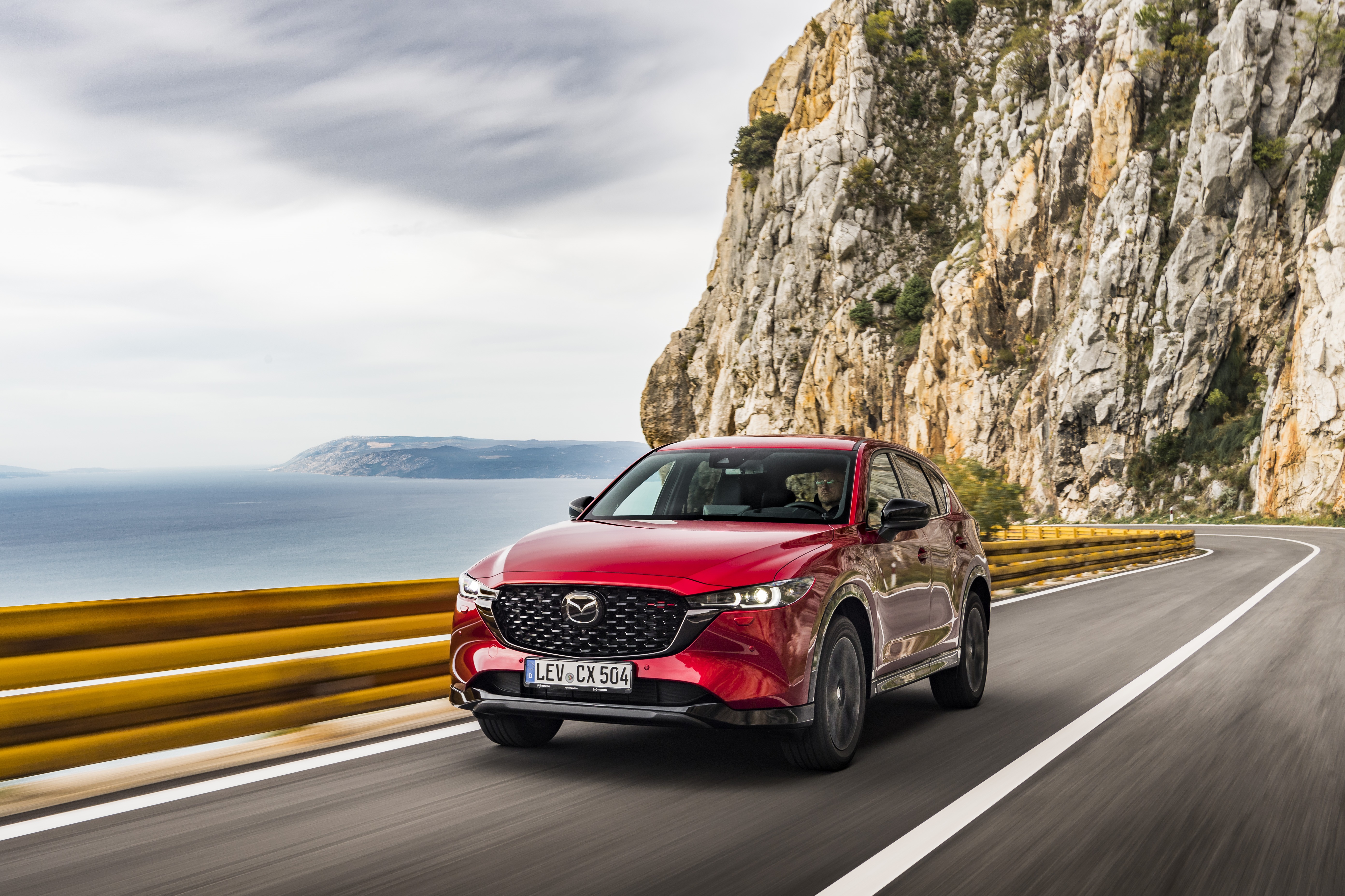 Red Mazda CX-5 Skyactiv-D 4K driving on coastal road HD Wallpaper