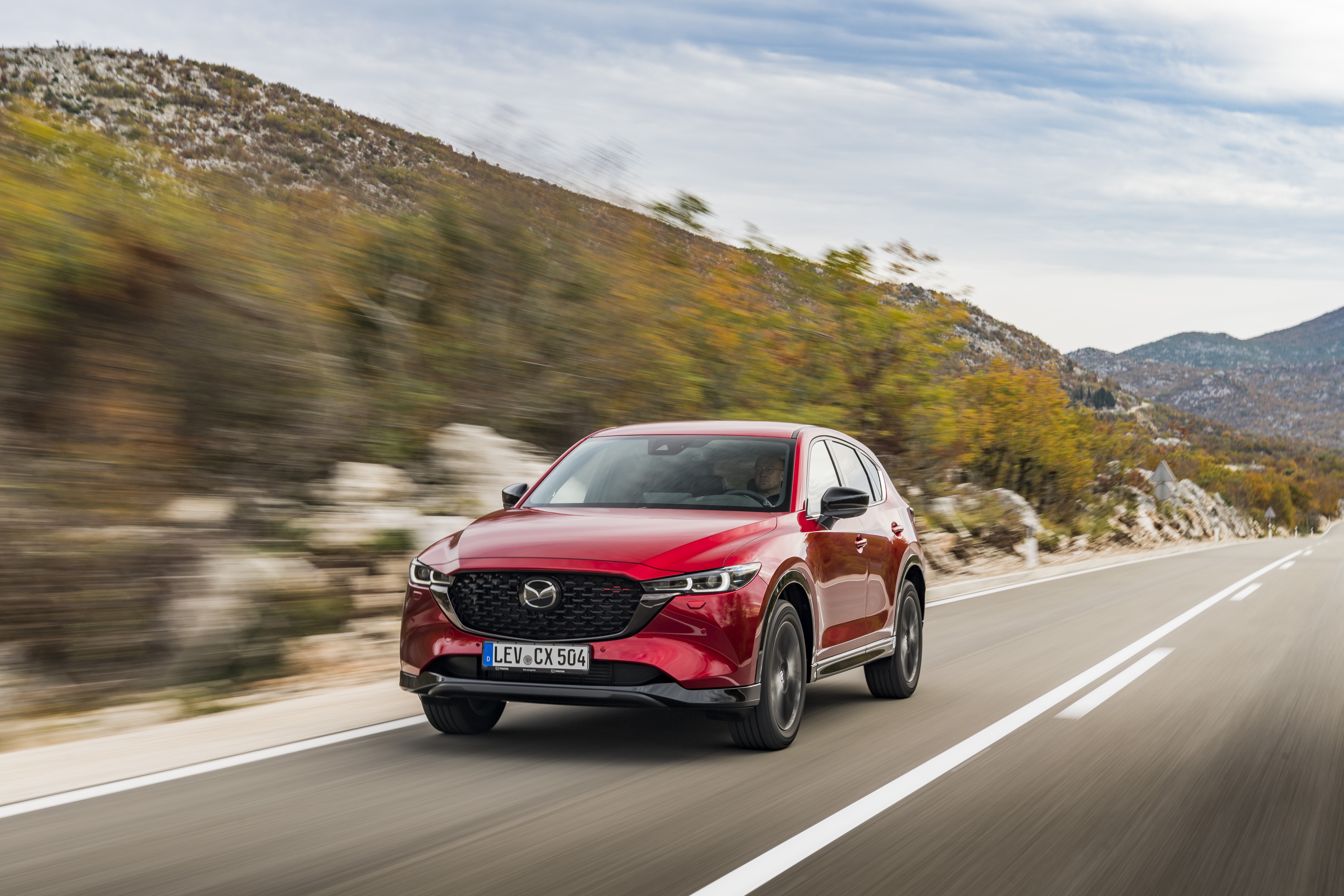 Red Mazda CX-5 Skyactiv-D 4K driving on a mountain road HD Wallpaper