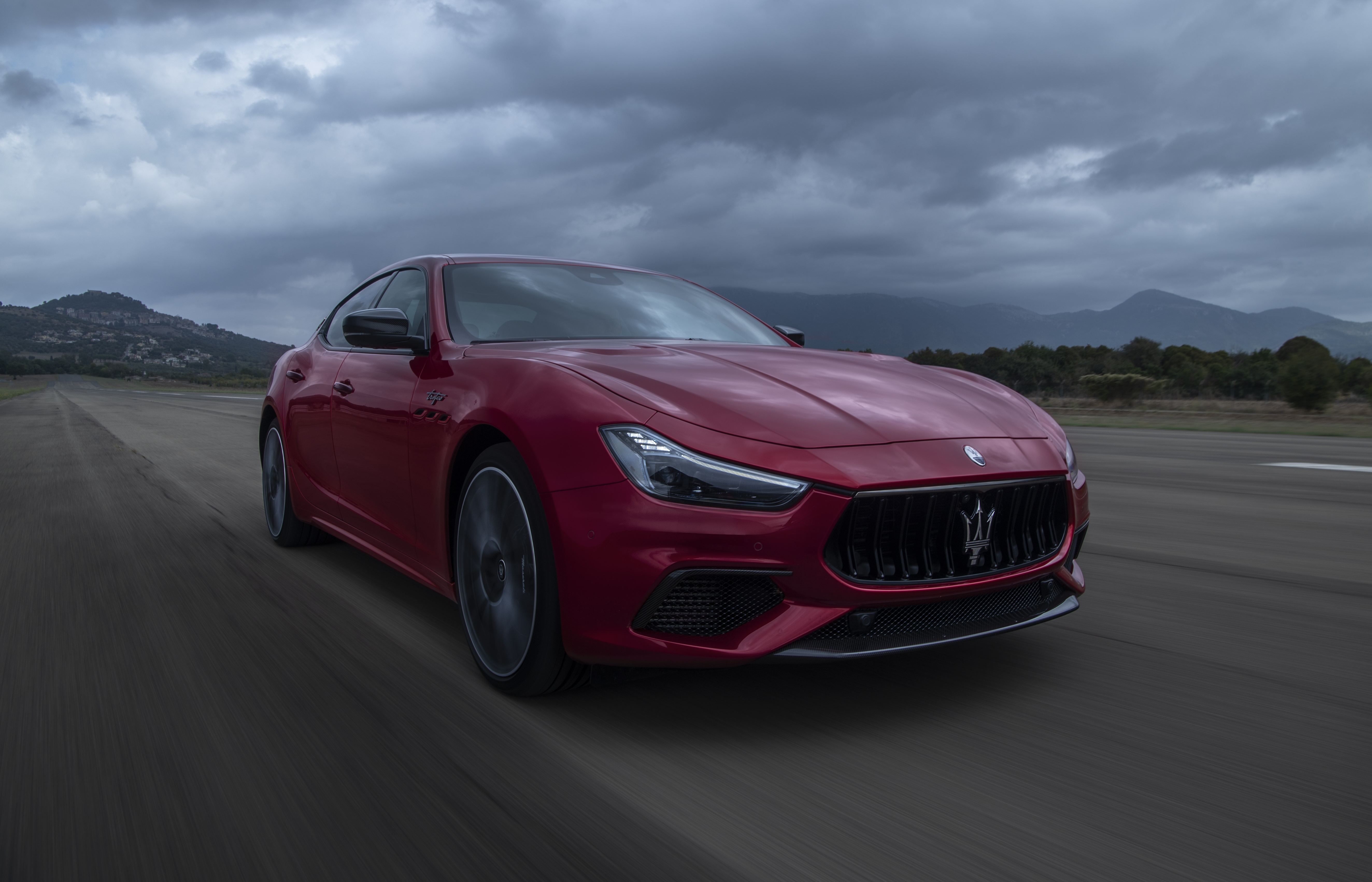 Red Maserati Ghibli Trofeo Carbon Pack driving on road HD Wallpaper