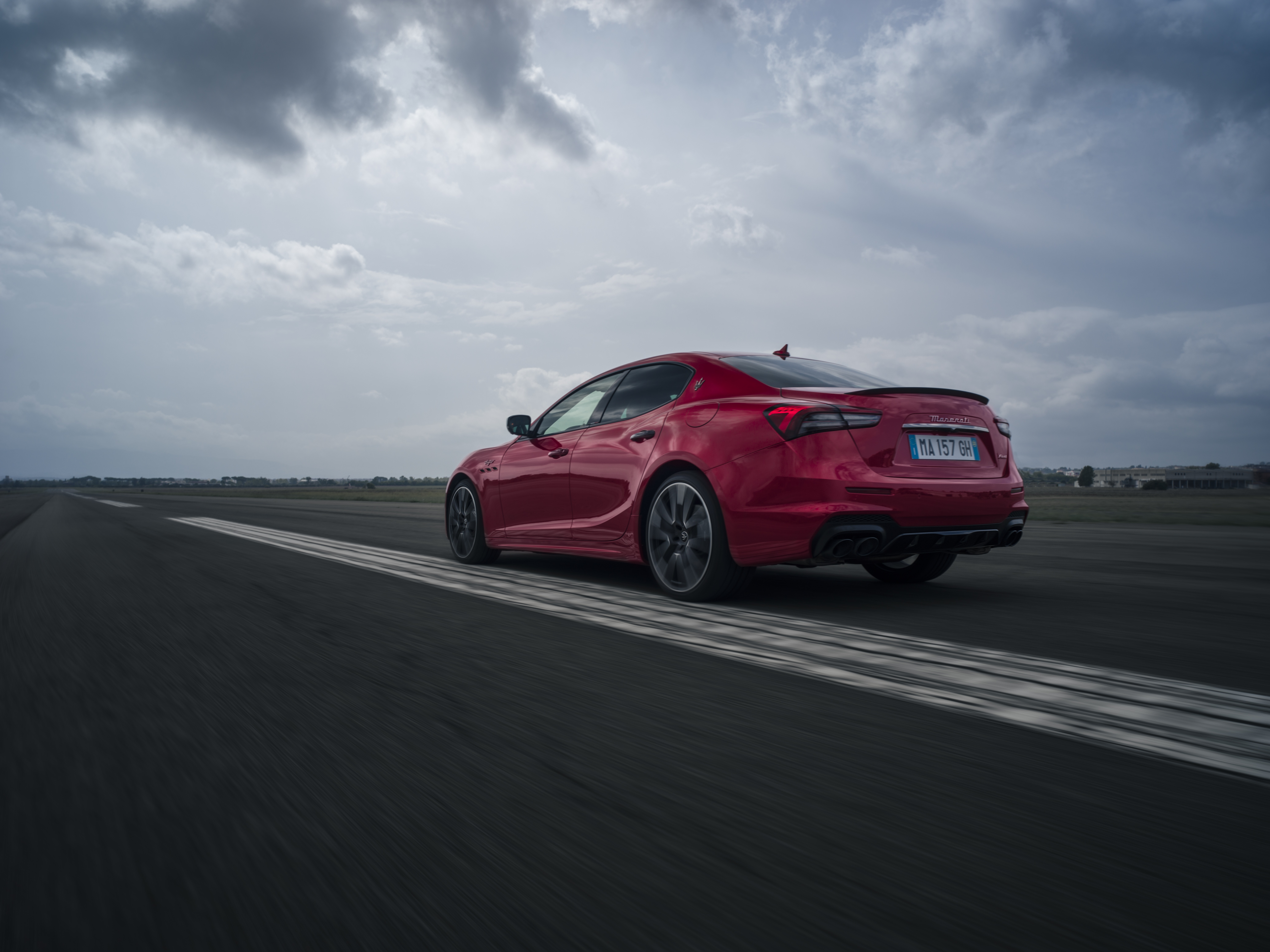 Red Maserati Ghibli Trofeo on a Racetrack HD Wallpaper
