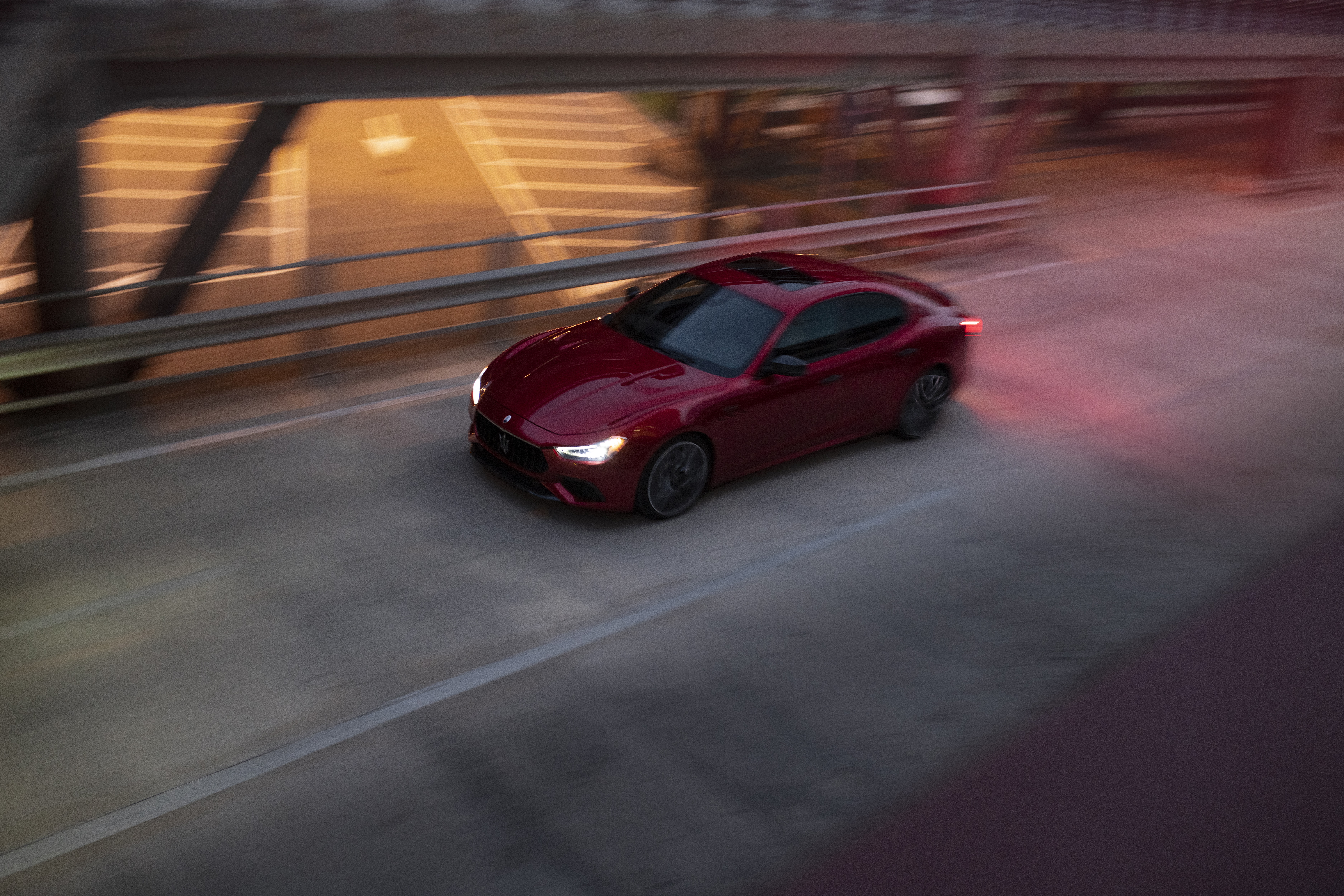 Red Maserati Ghibli driving on a bridge HD Wallpaper