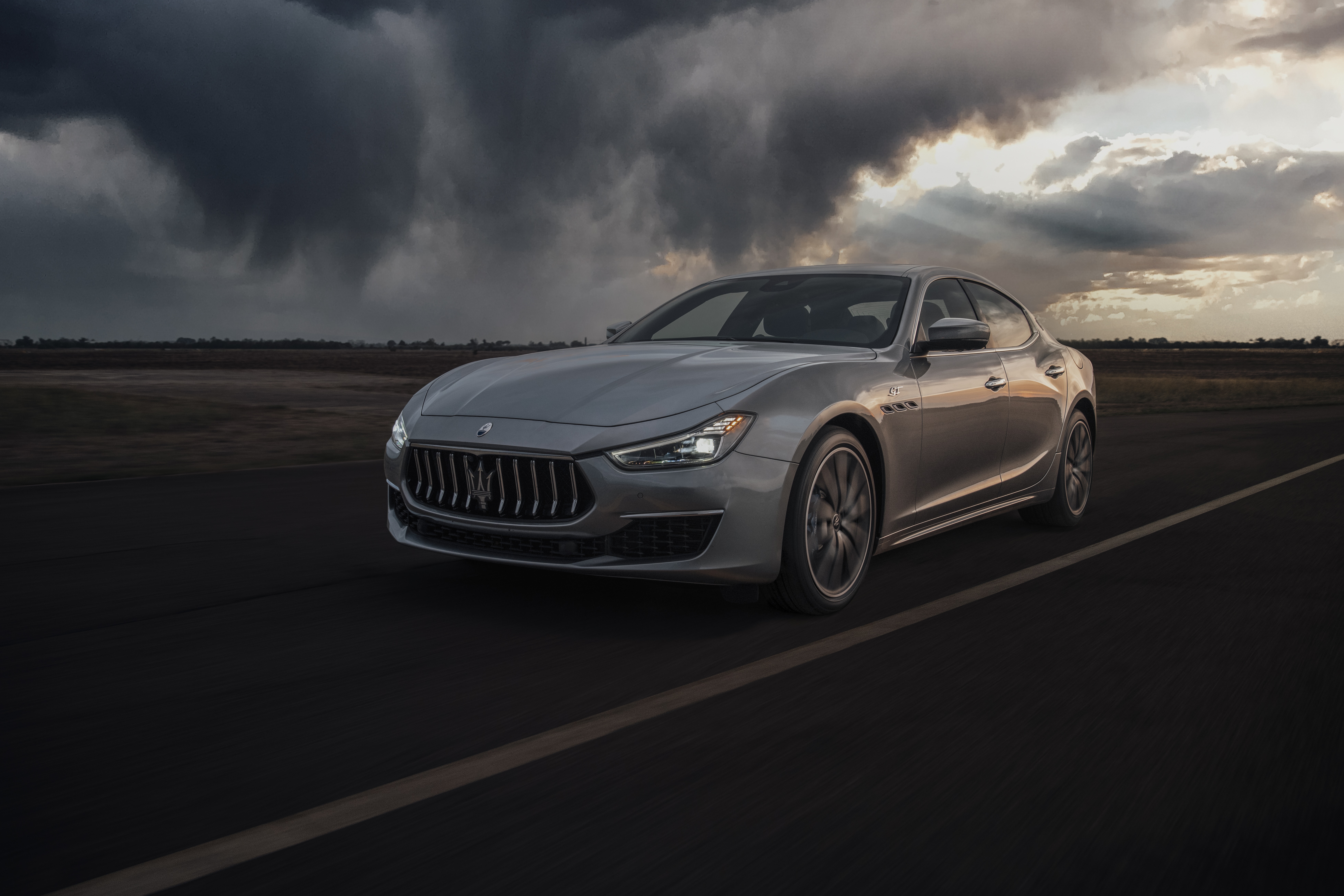 Silver Maserati Ghibli GT Hybrid driving on a road HD Wallpaper