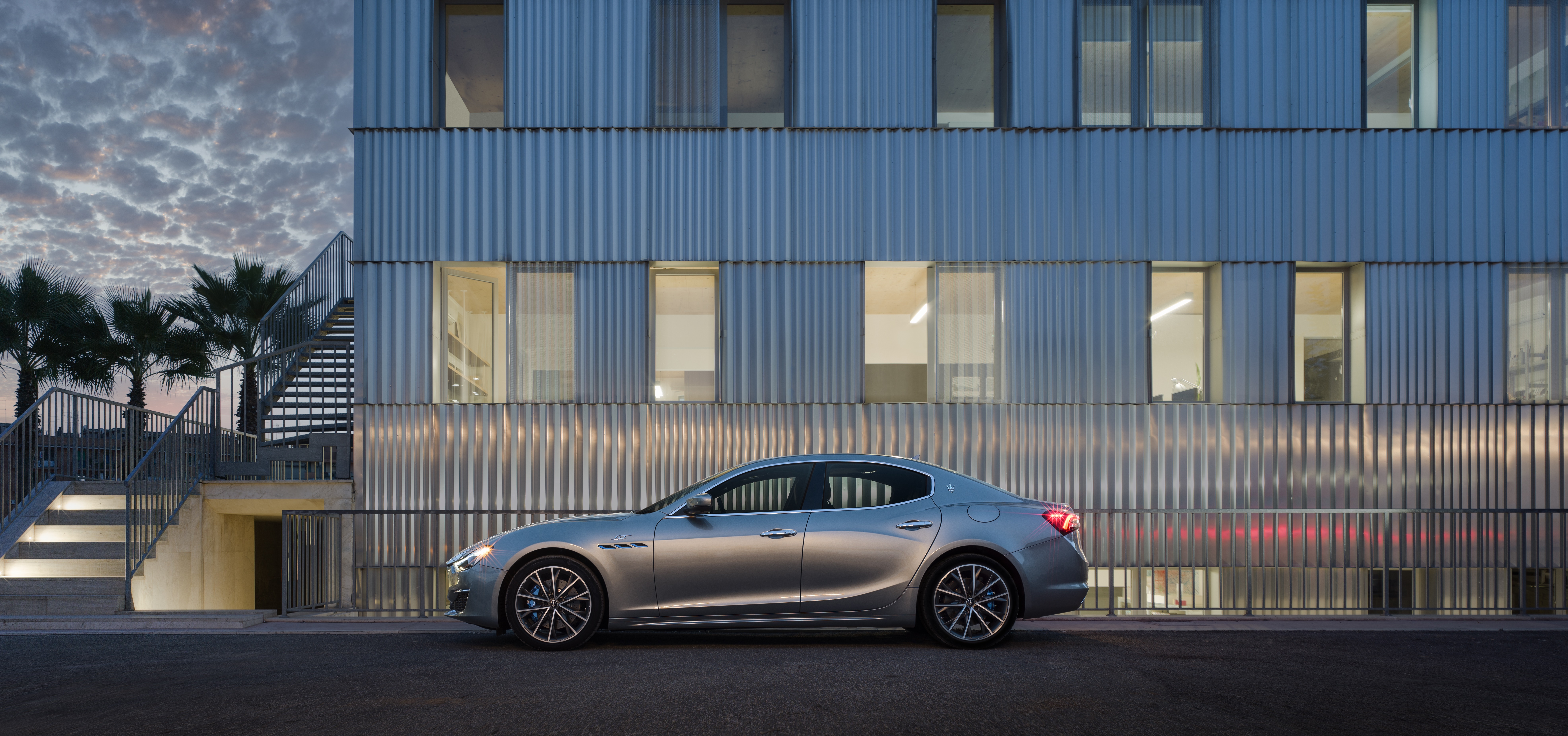 Maserati Ghibli GT Hybrid parked by modern building HD Wallpaper