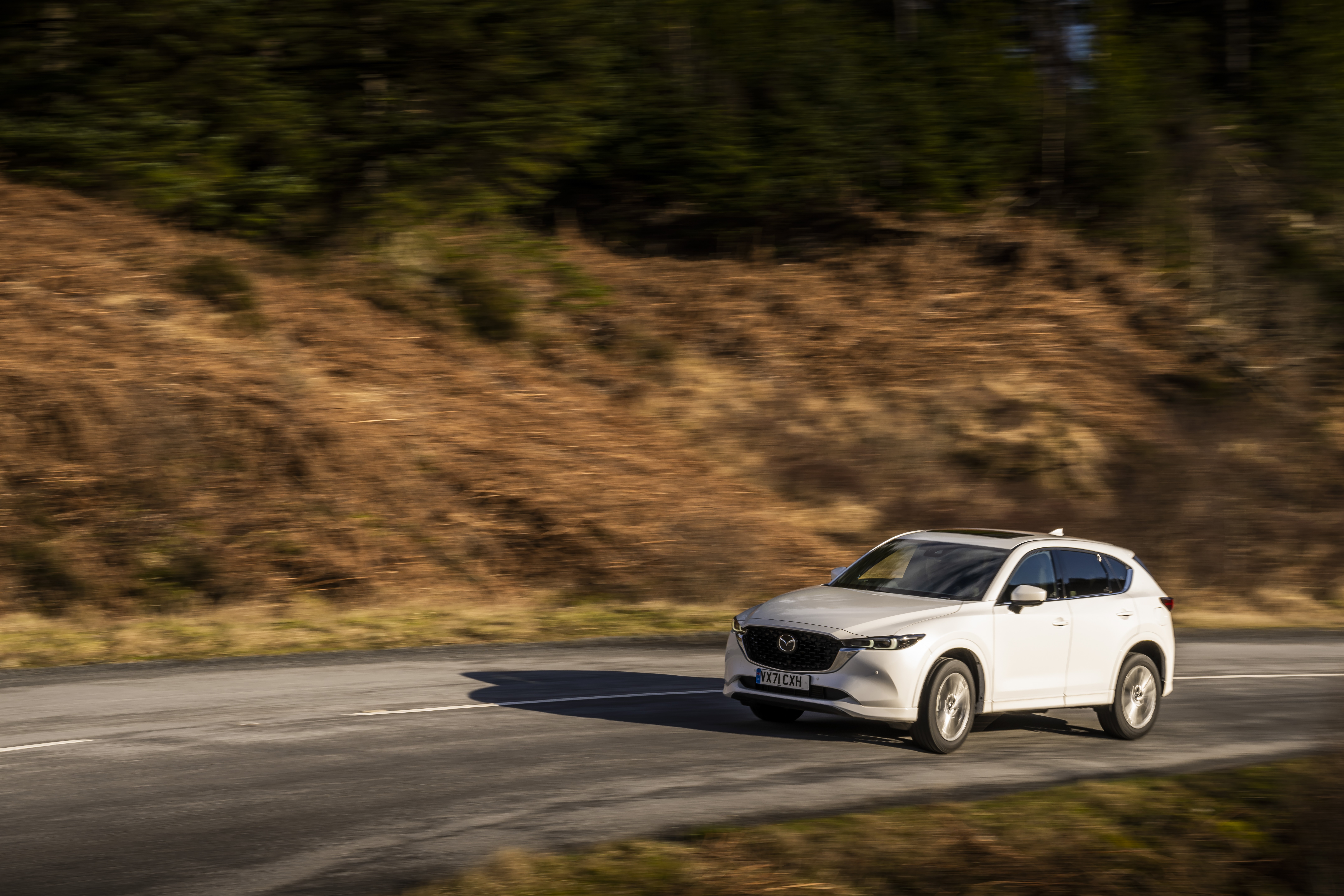 White Mazda CX-5 SUV driving on a road HD Wallpaper