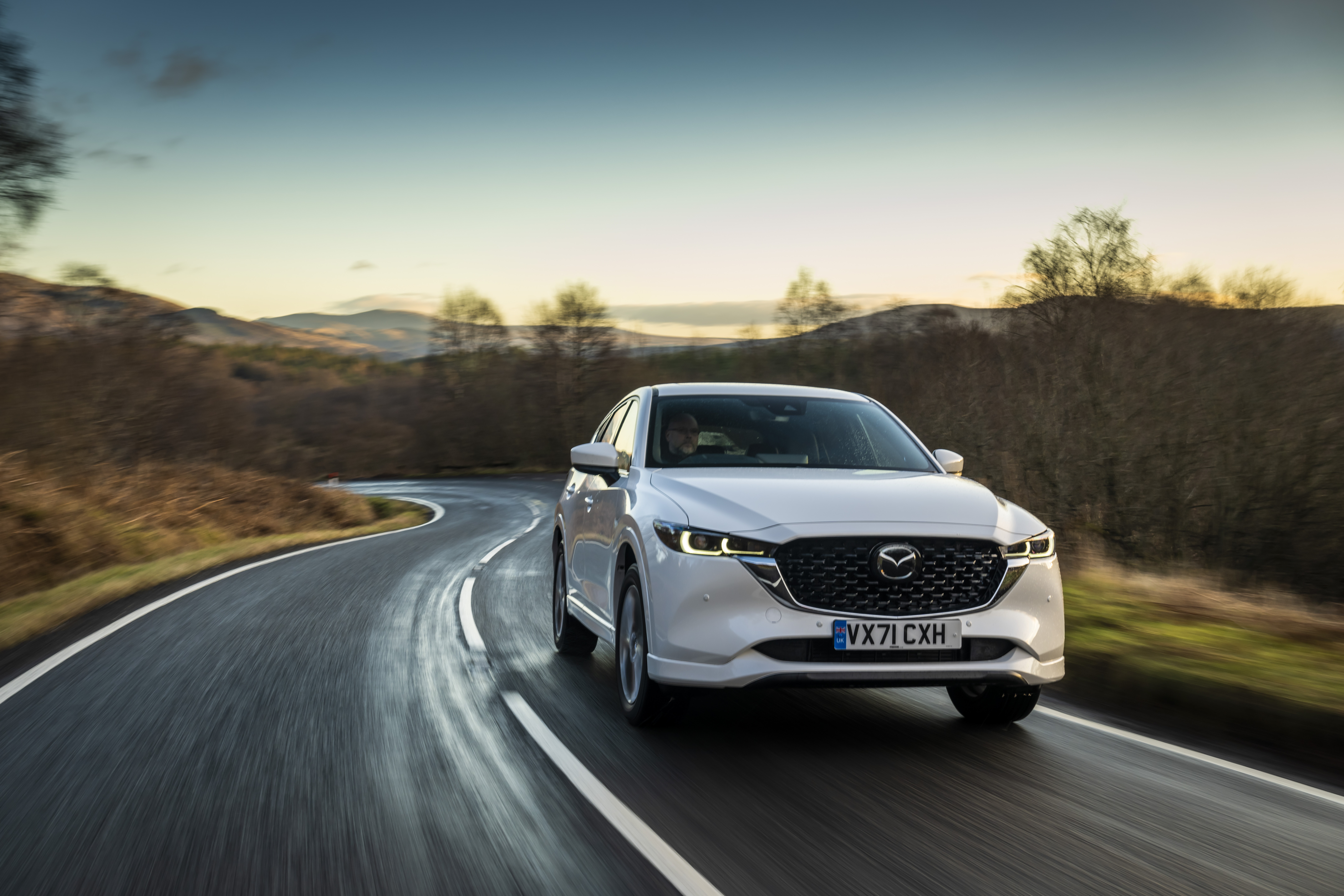 White Mazda CX-5 driving on a winding road HD Wallpaper