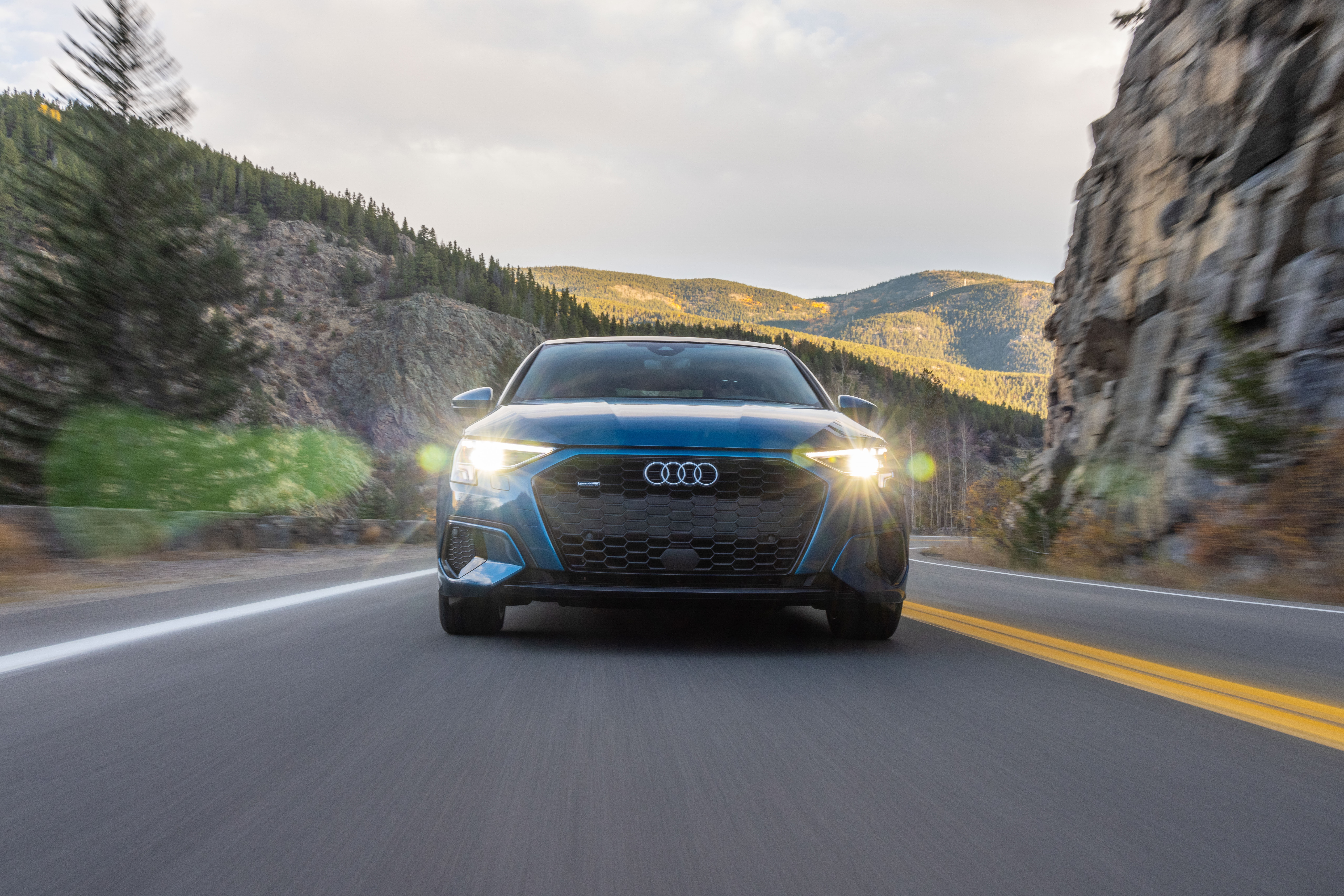 Blue Audi A3 Sedan 40 TFSI quattro driving on mountain road HD Wallpaper