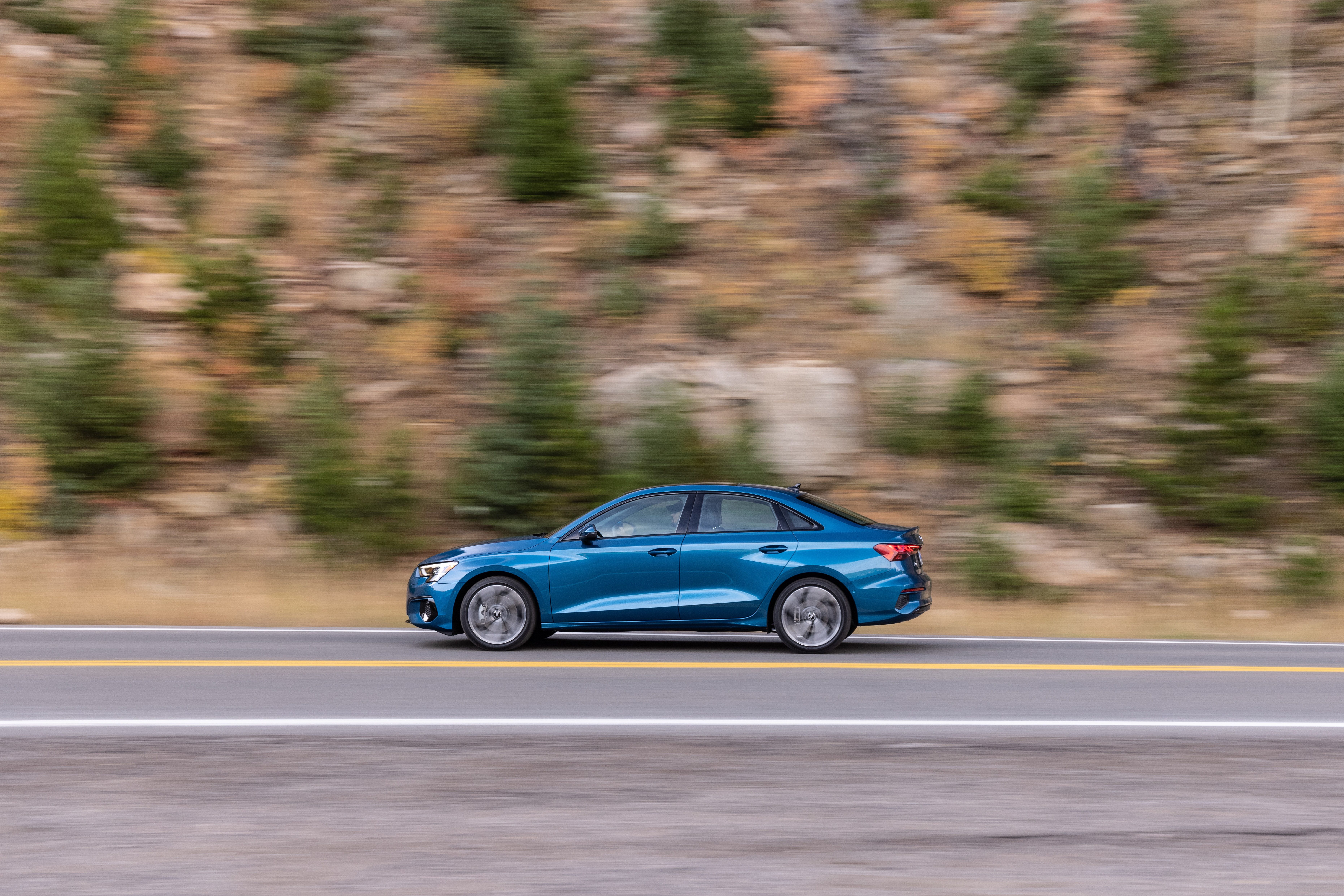 Blue Audi A3 Sedan 40 TFSI quattro driving on a road HD Wallpaper