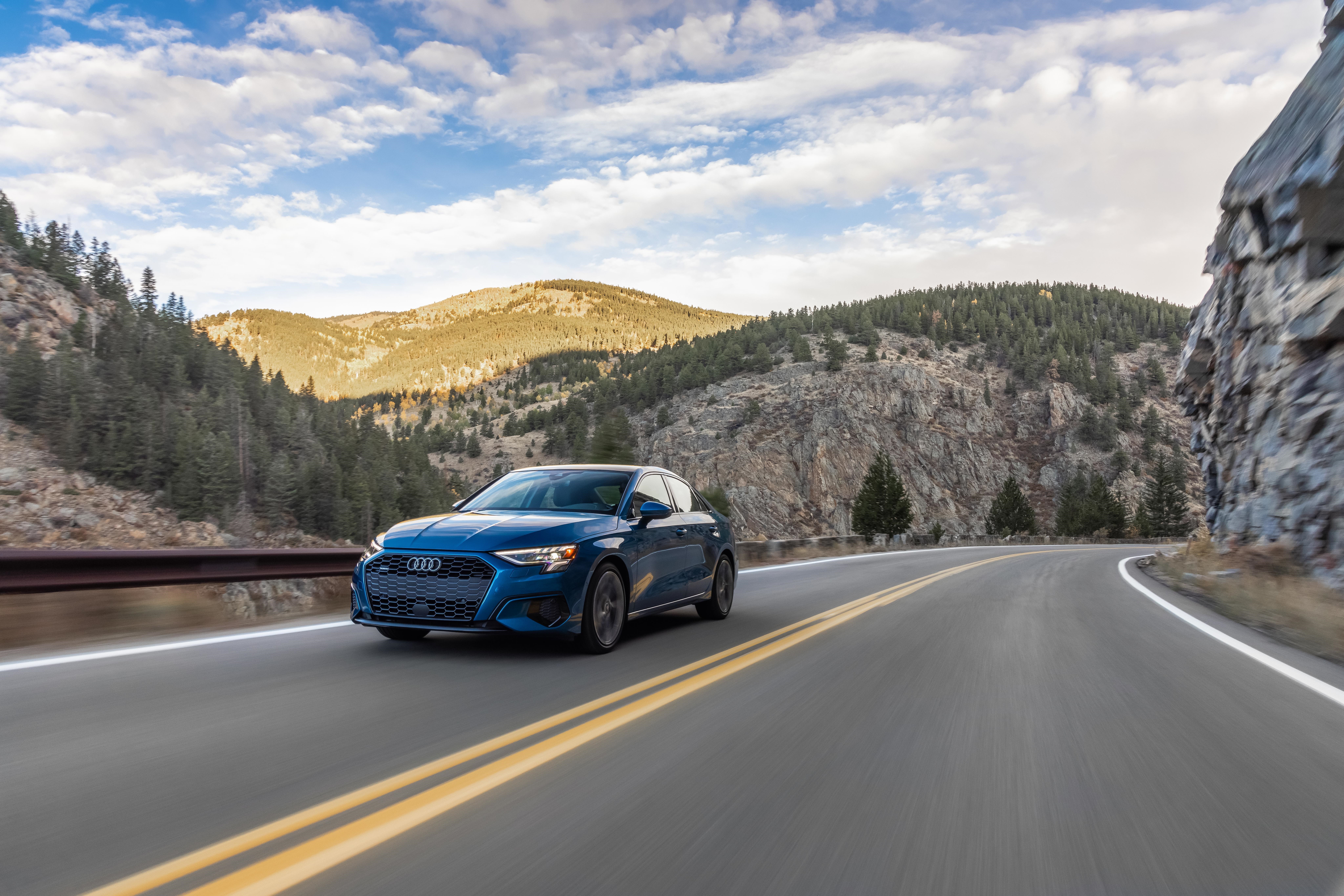 Blue Audi A3 Sedan driving on a mountain road HD Wallpaper