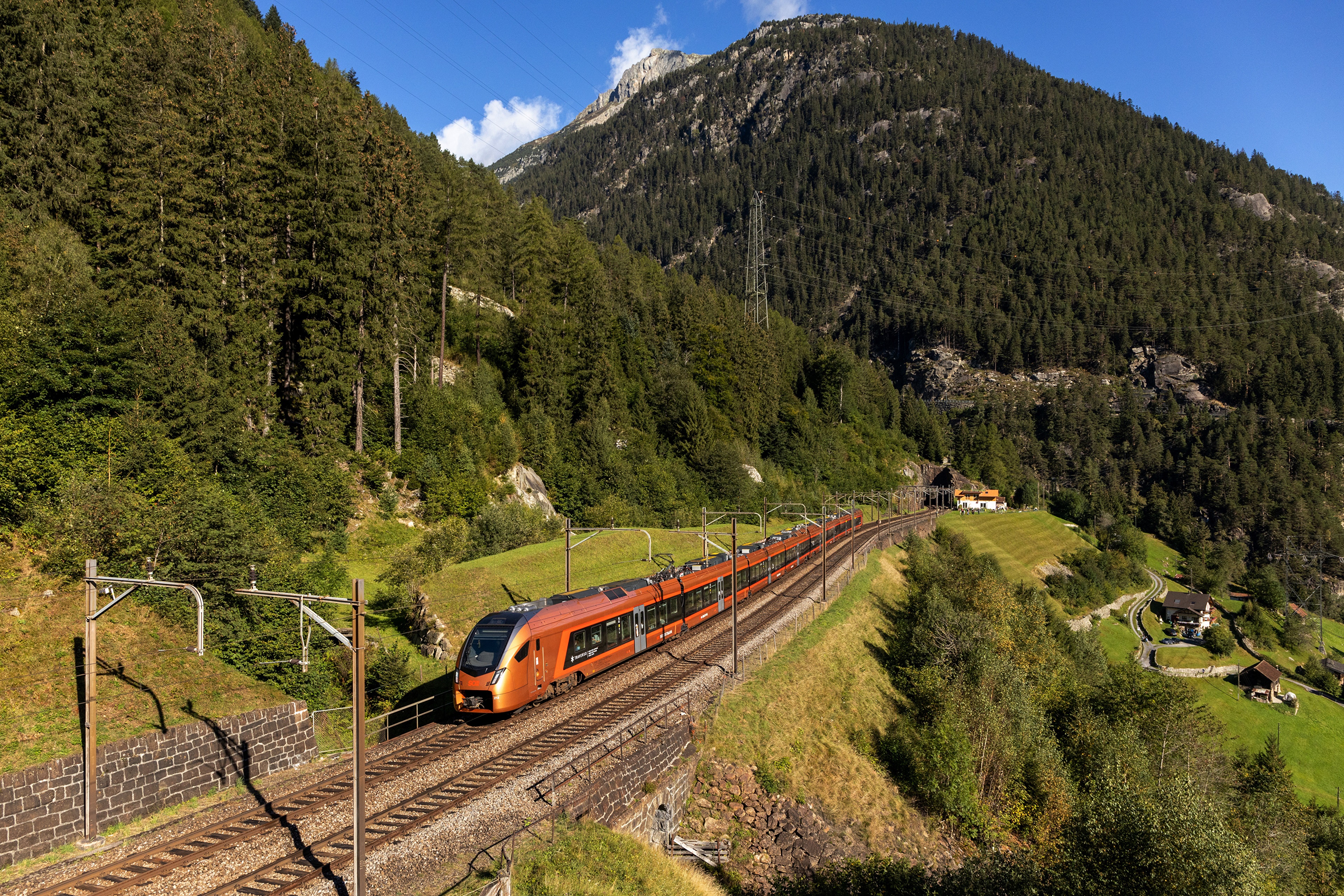 Orange train in the Swiss Alps HD Wallpaper