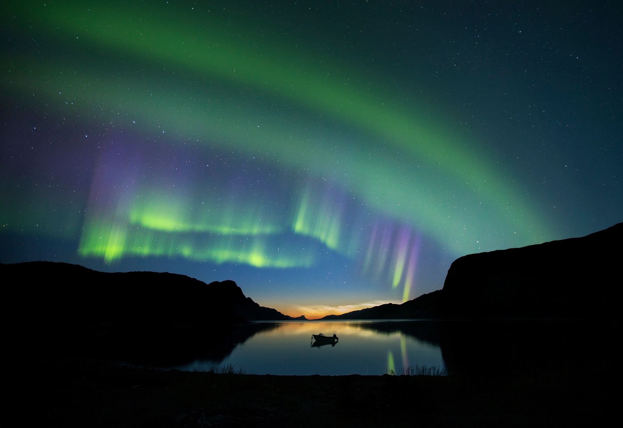 Aurora Borealis over a lake with a boat HD Wallpaper