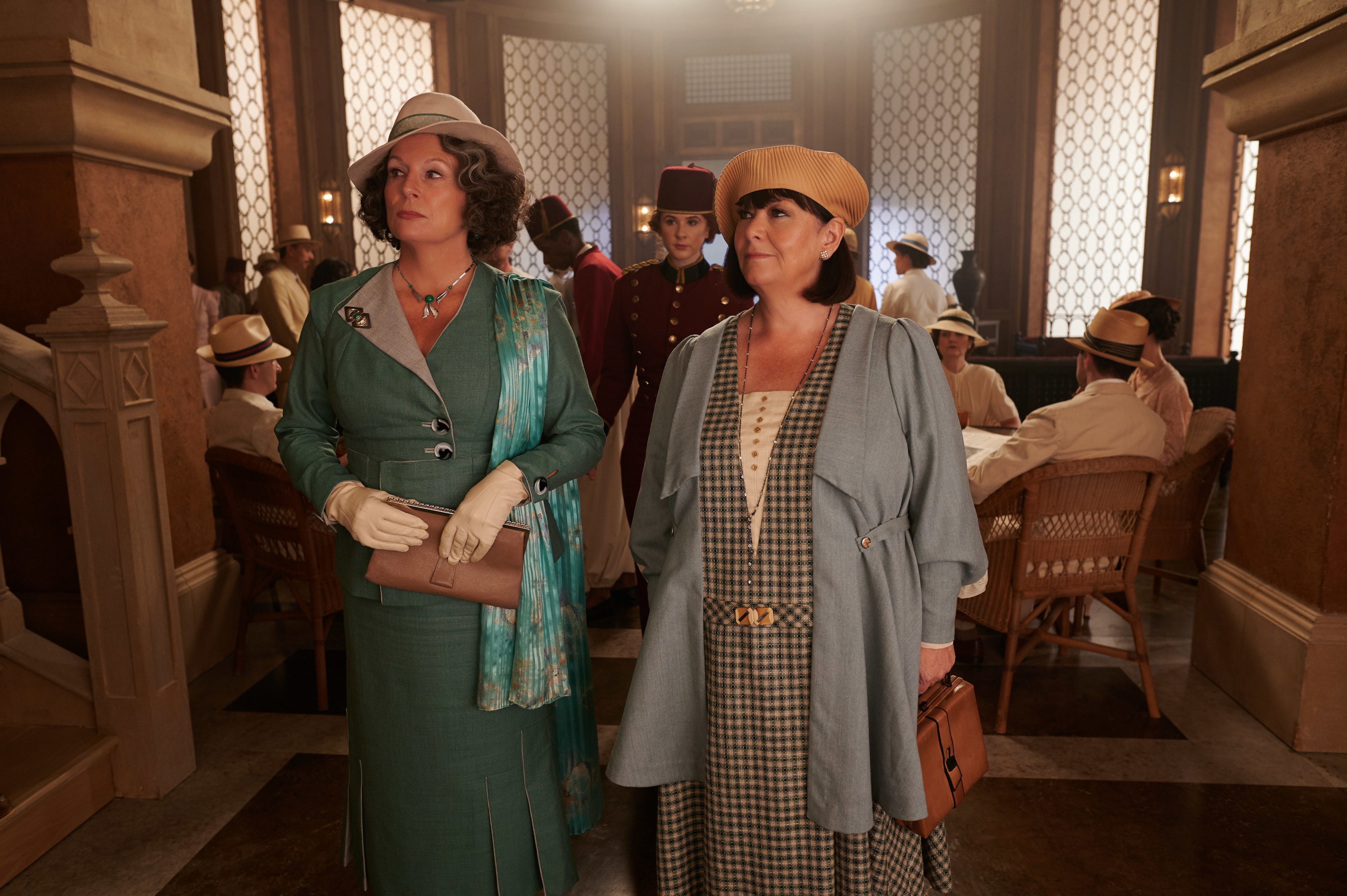 Two women in vintage clothing in a grand hall HD Wallpaper