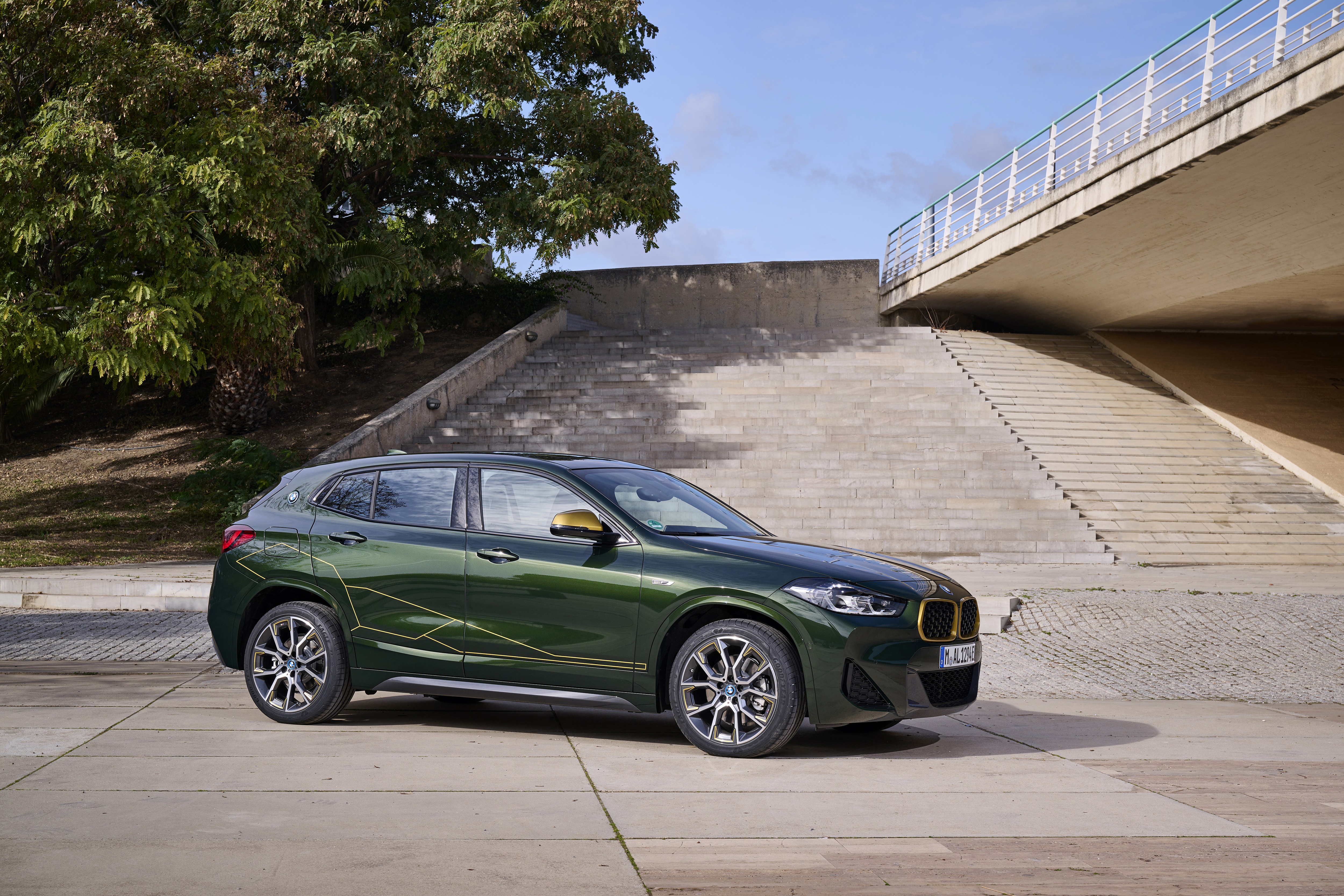 Green BMW X2 xDrive25e SUV with gold accents HD Wallpaper