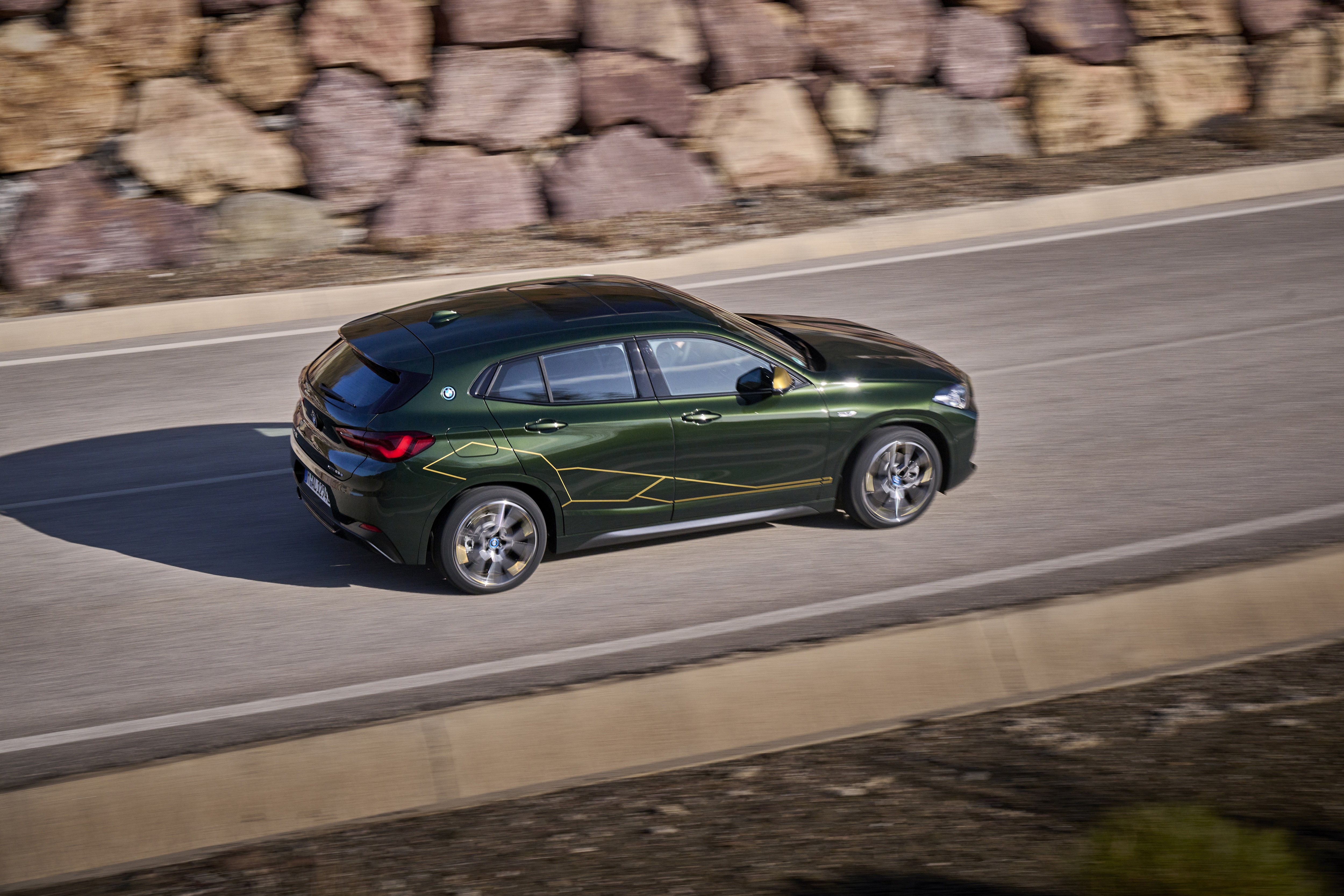 BMW X2 xDrive25e driving on a road HD Wallpaper