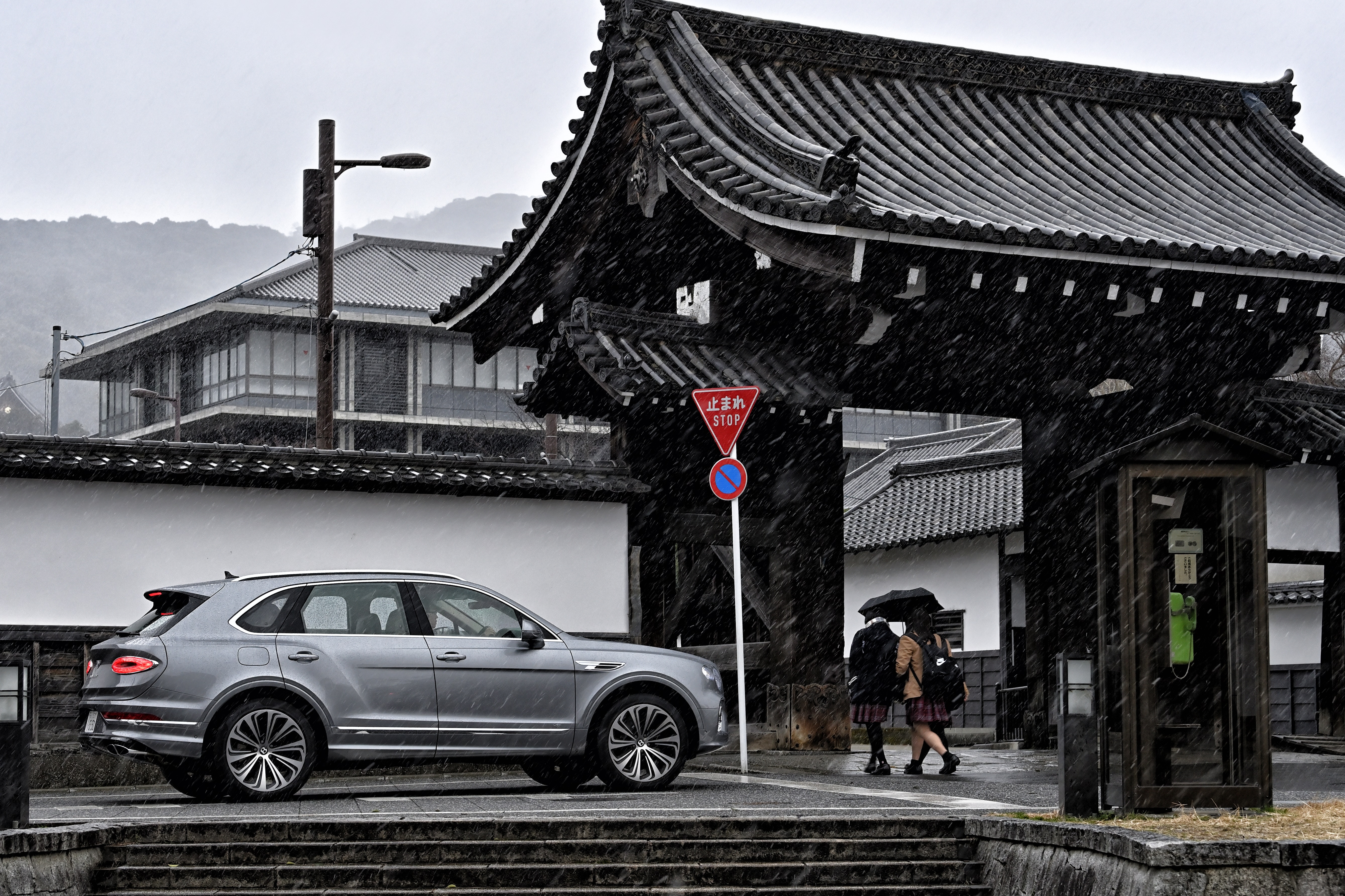 Bentley Bentayga SUV in front of Japanese temple gate HD Wallpaper