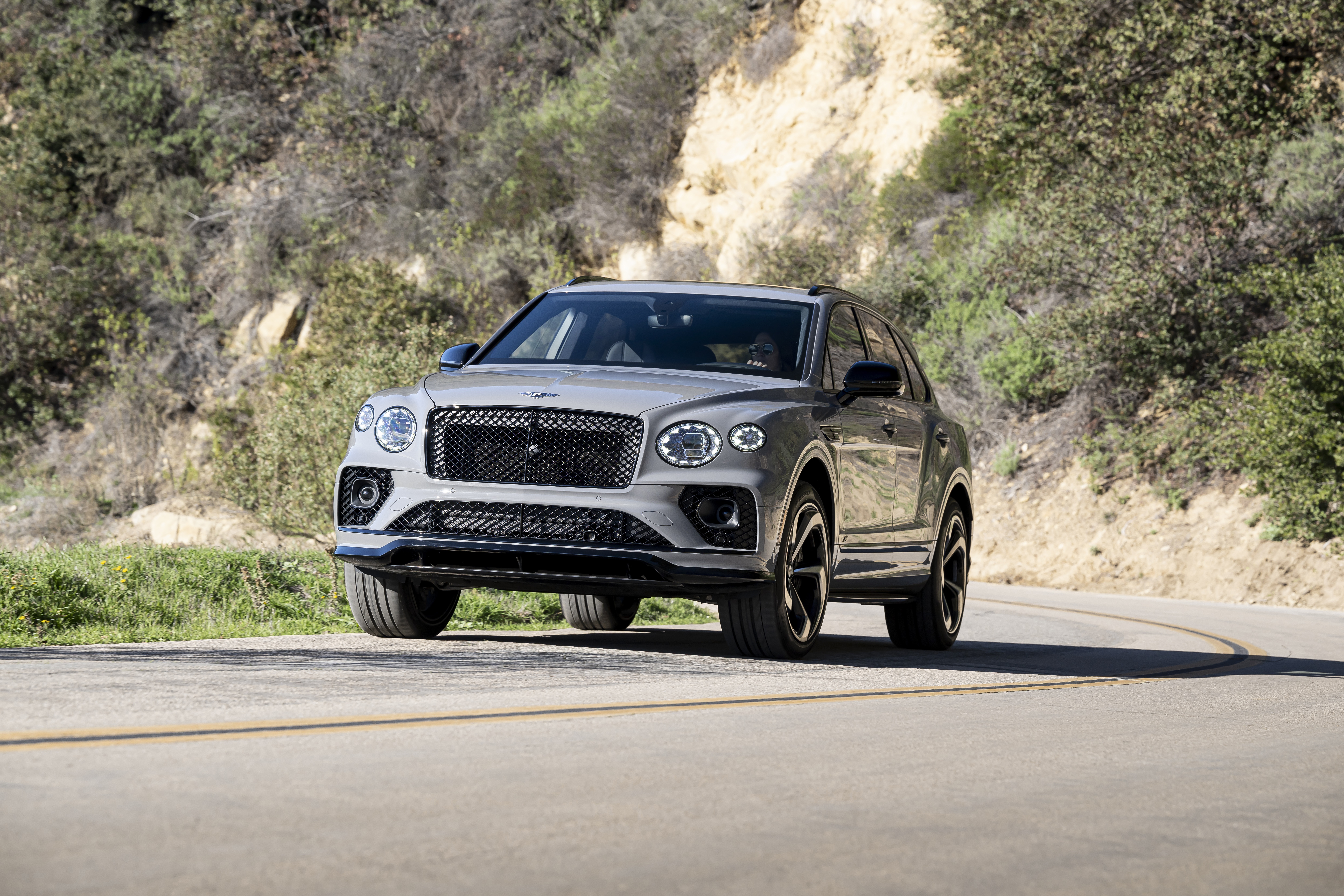 Bentley Bentayga S SUV driving on a winding road HD Wallpaper