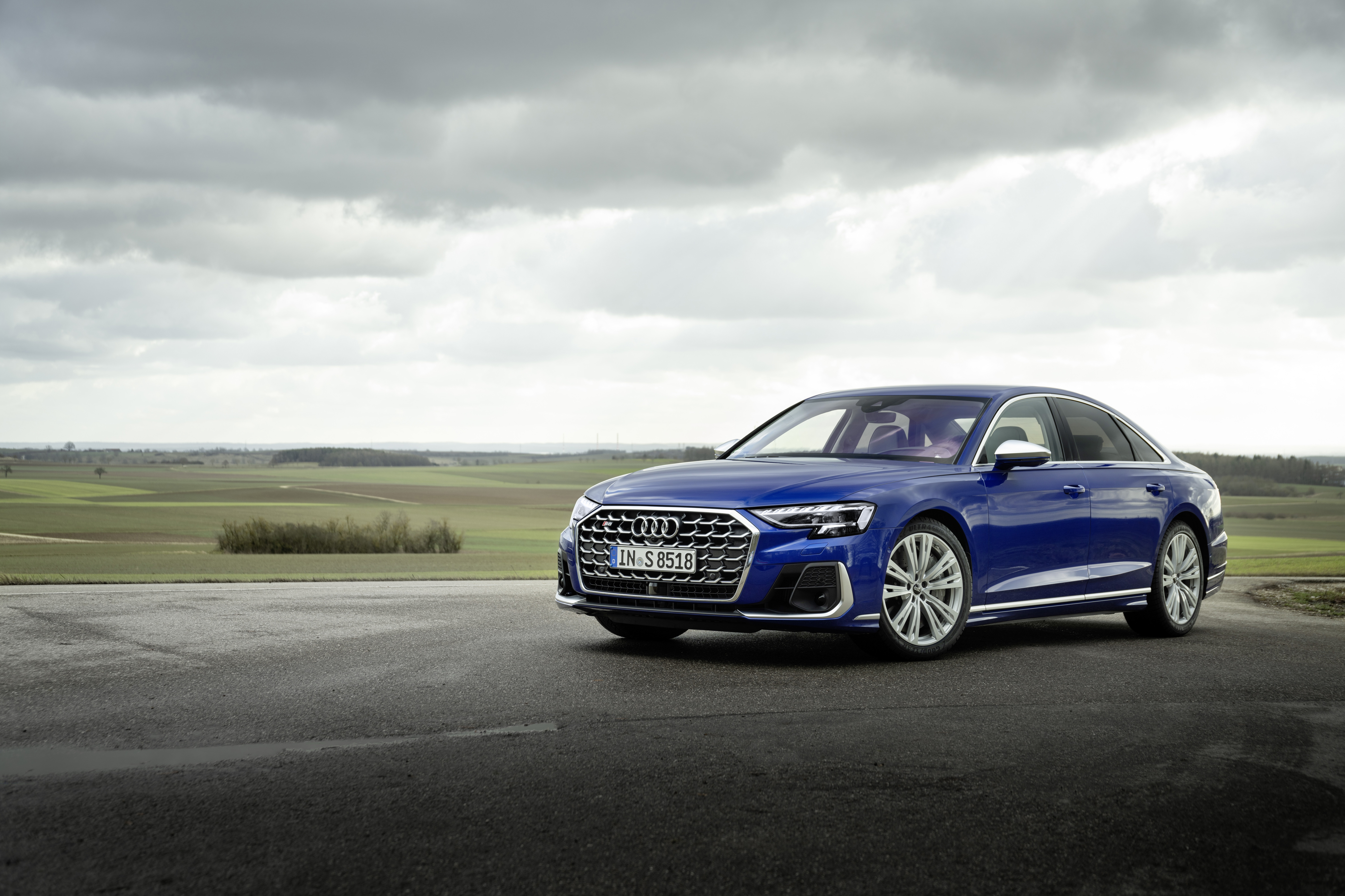 Blue Audi S8 parked on a road with fields in the background HD Wallpaper