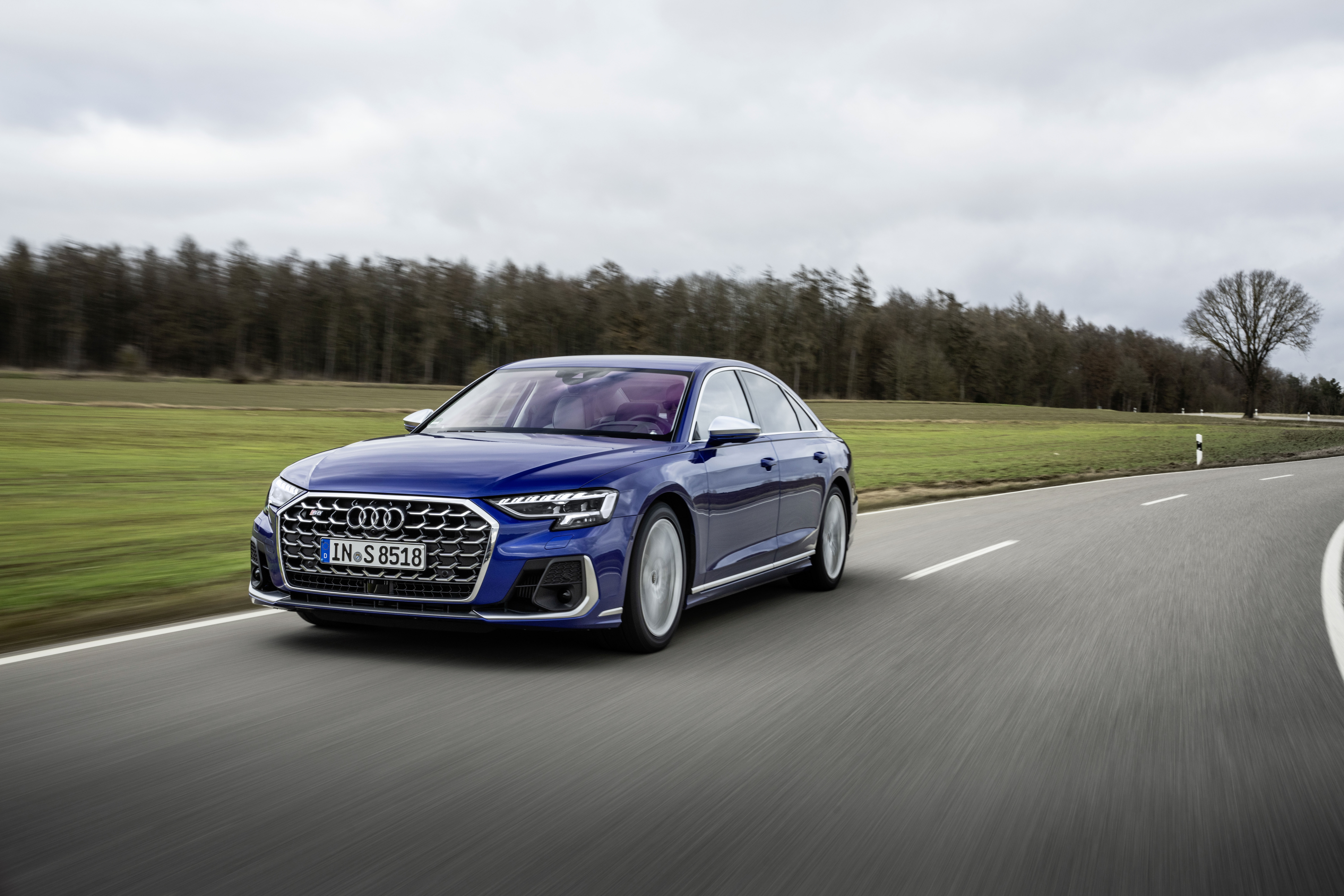 Blue Audi S8 driving on a road HD Wallpaper