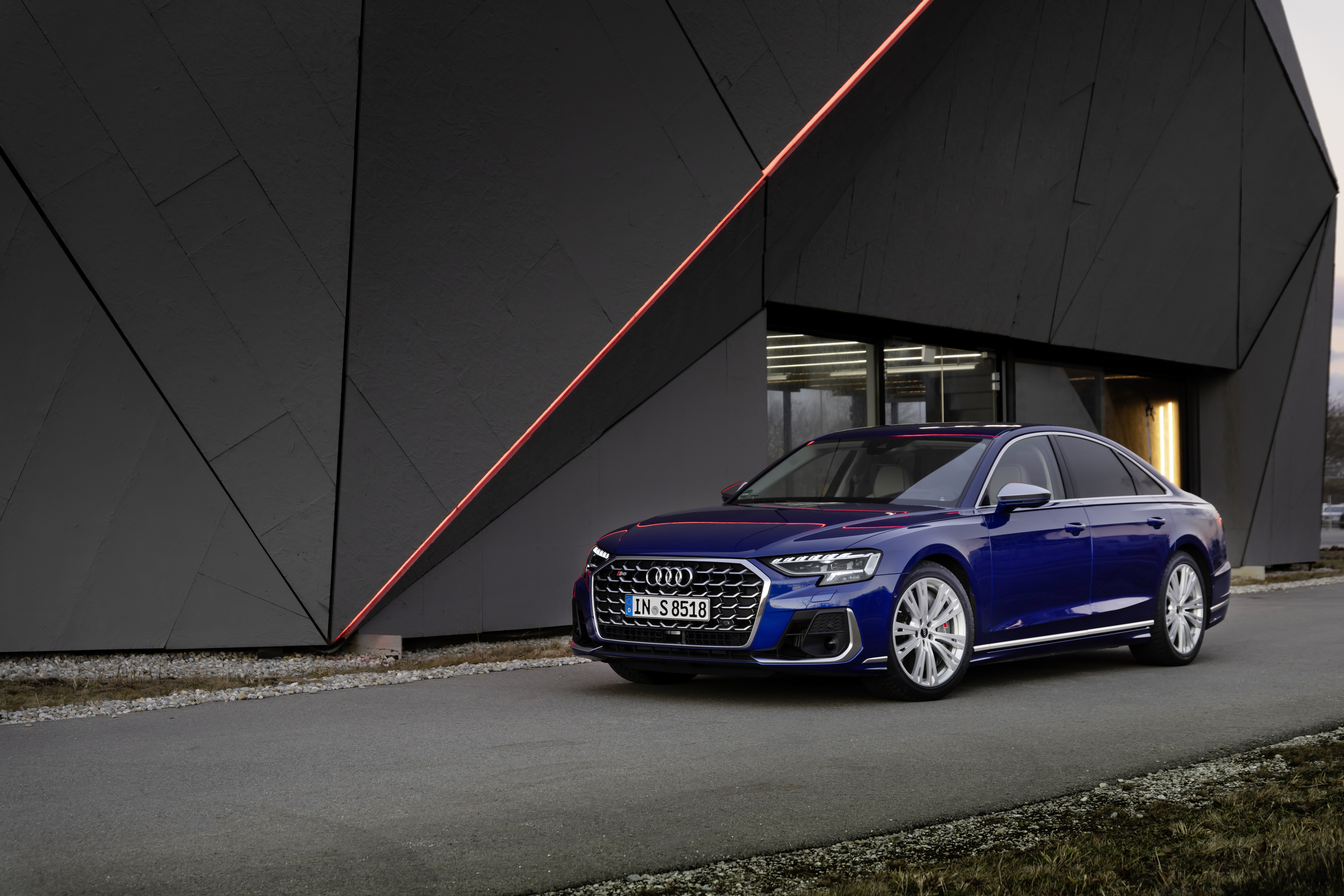 Blue Audi S8 parked in front of a modern building HD Wallpaper