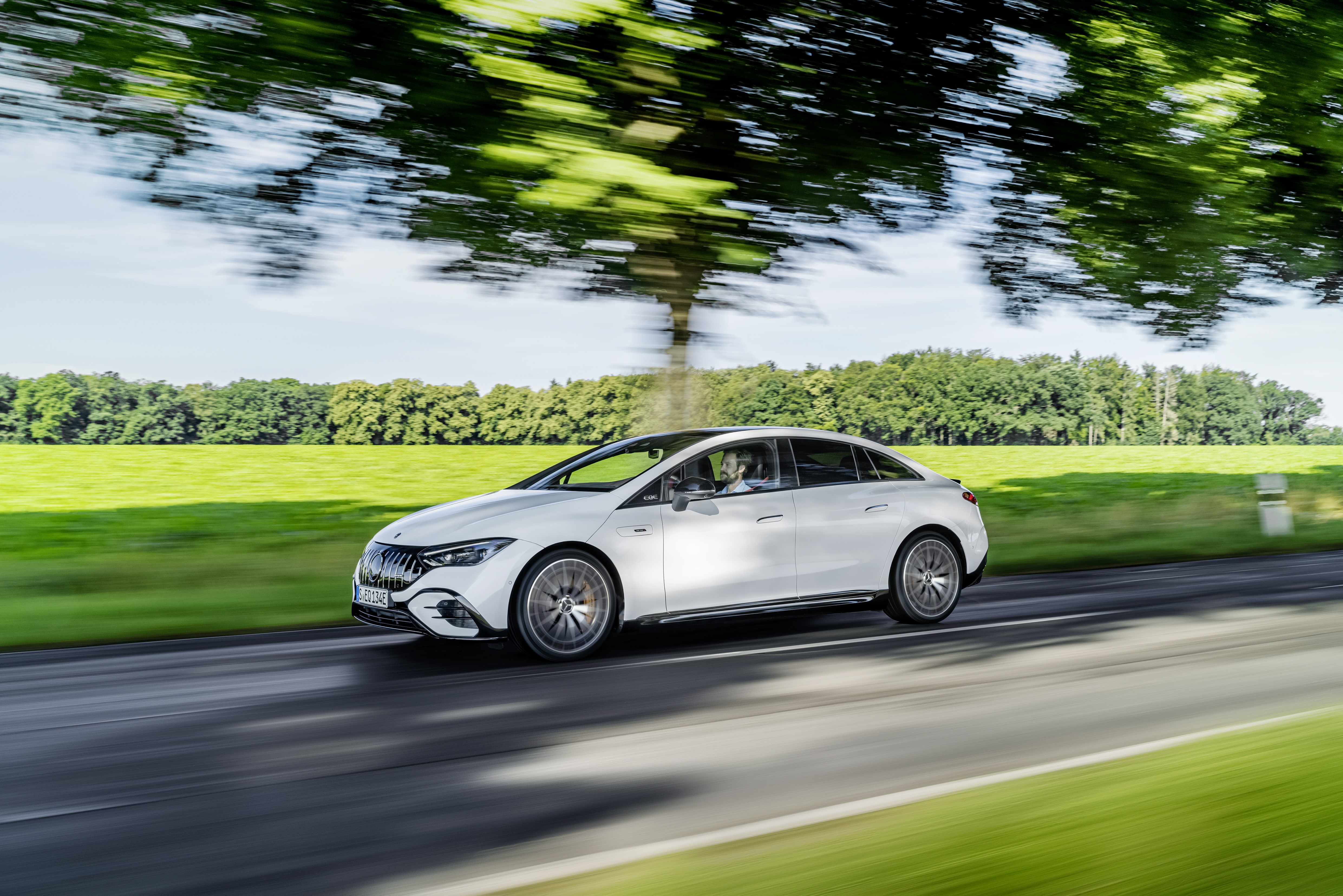 Mercedes-AMG EQE 43 4K driving on a road HD Wallpaper