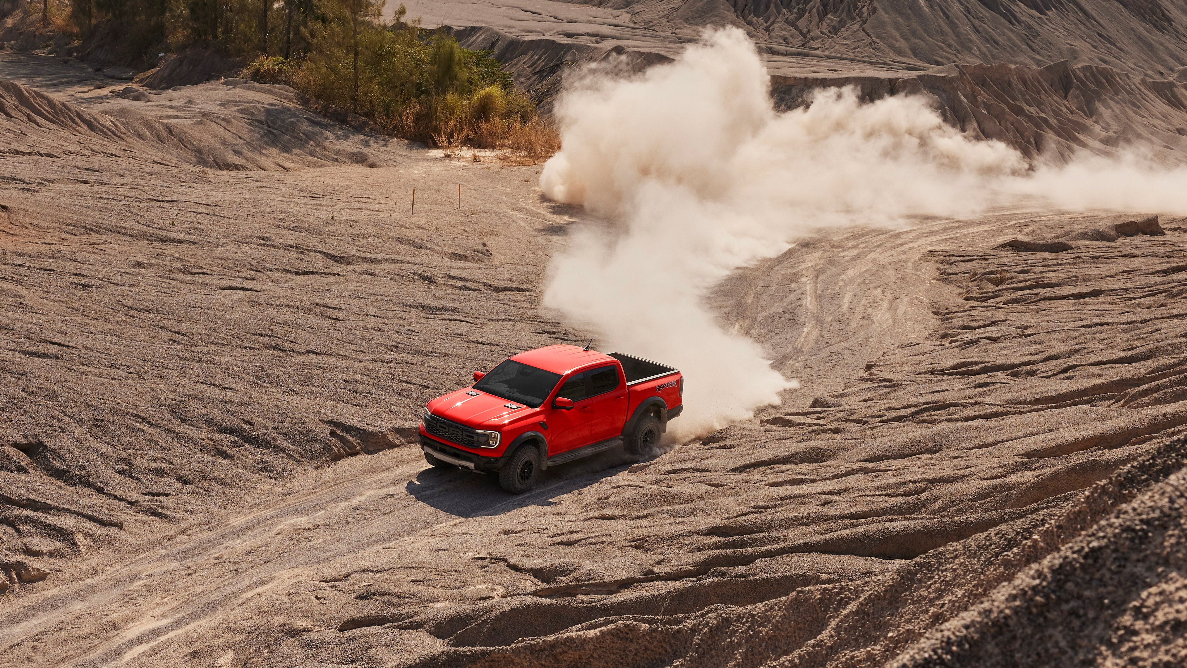 Red Ford Ranger Raptor driving through gravel pit HD Wallpaper