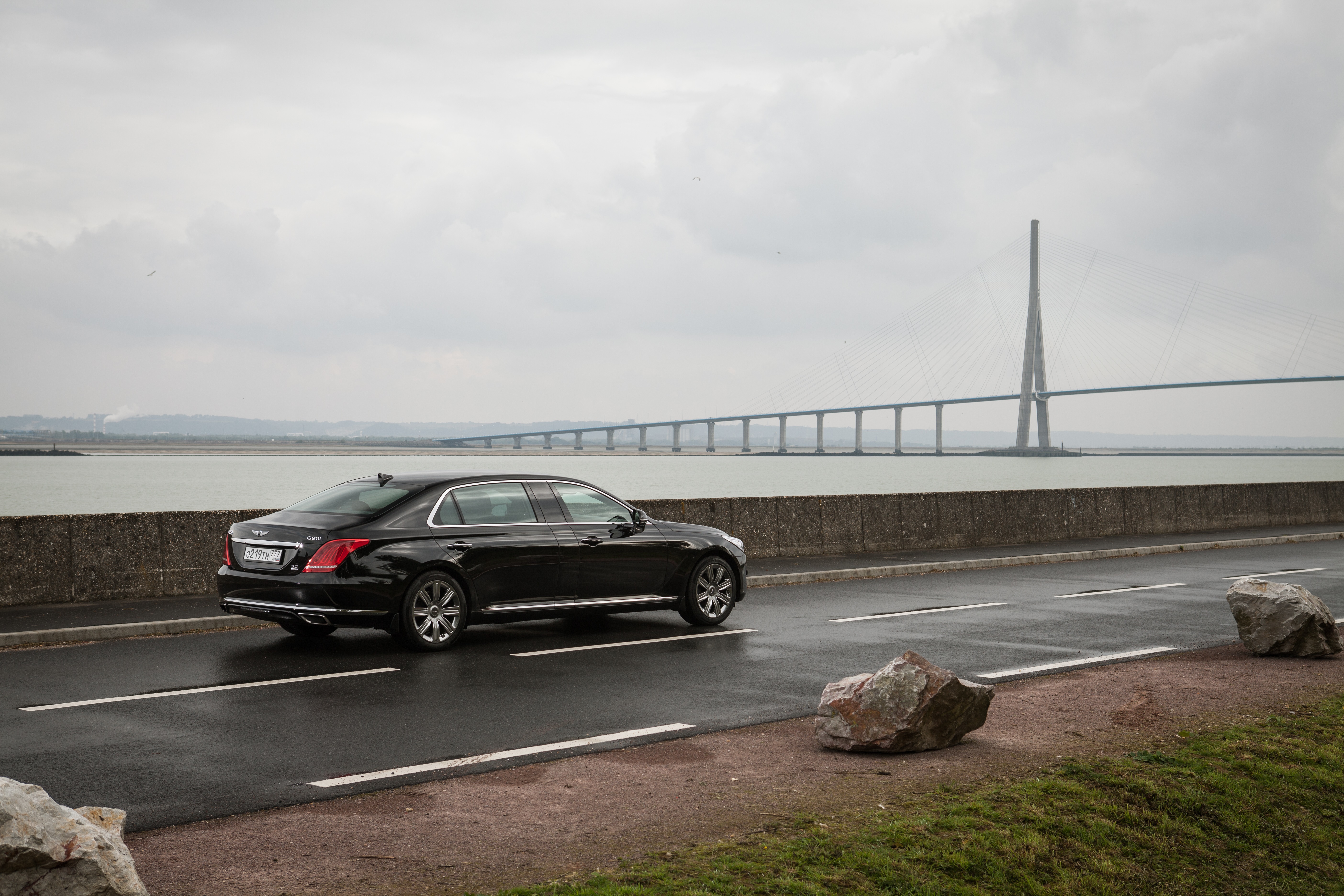 Black Genesis G90L 5.0 HTRAC car on road near bridge HD Wallpaper