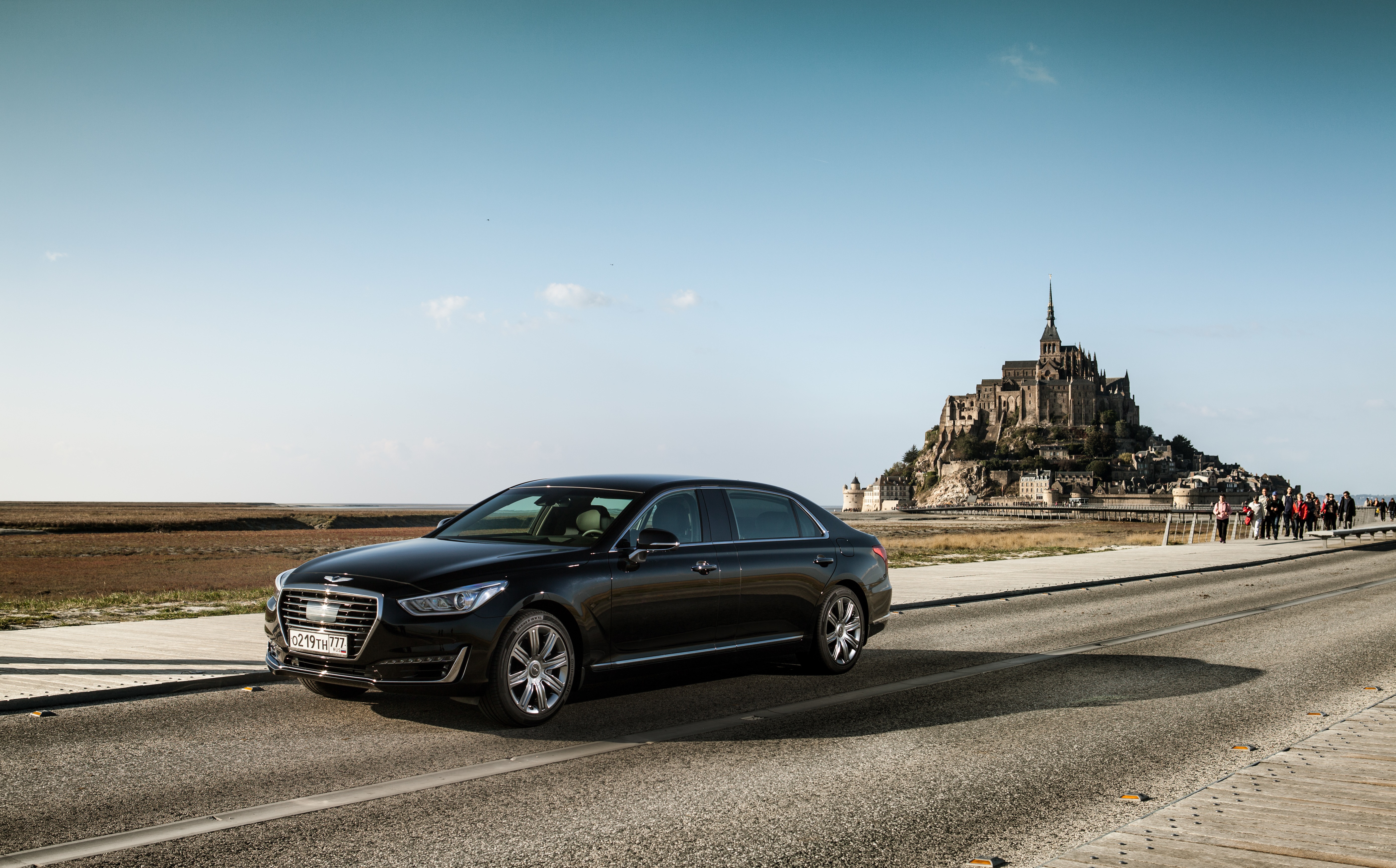 Black Genesis G90L 5.0 HTRAC car near Mont Saint-Michel HD Wallpaper