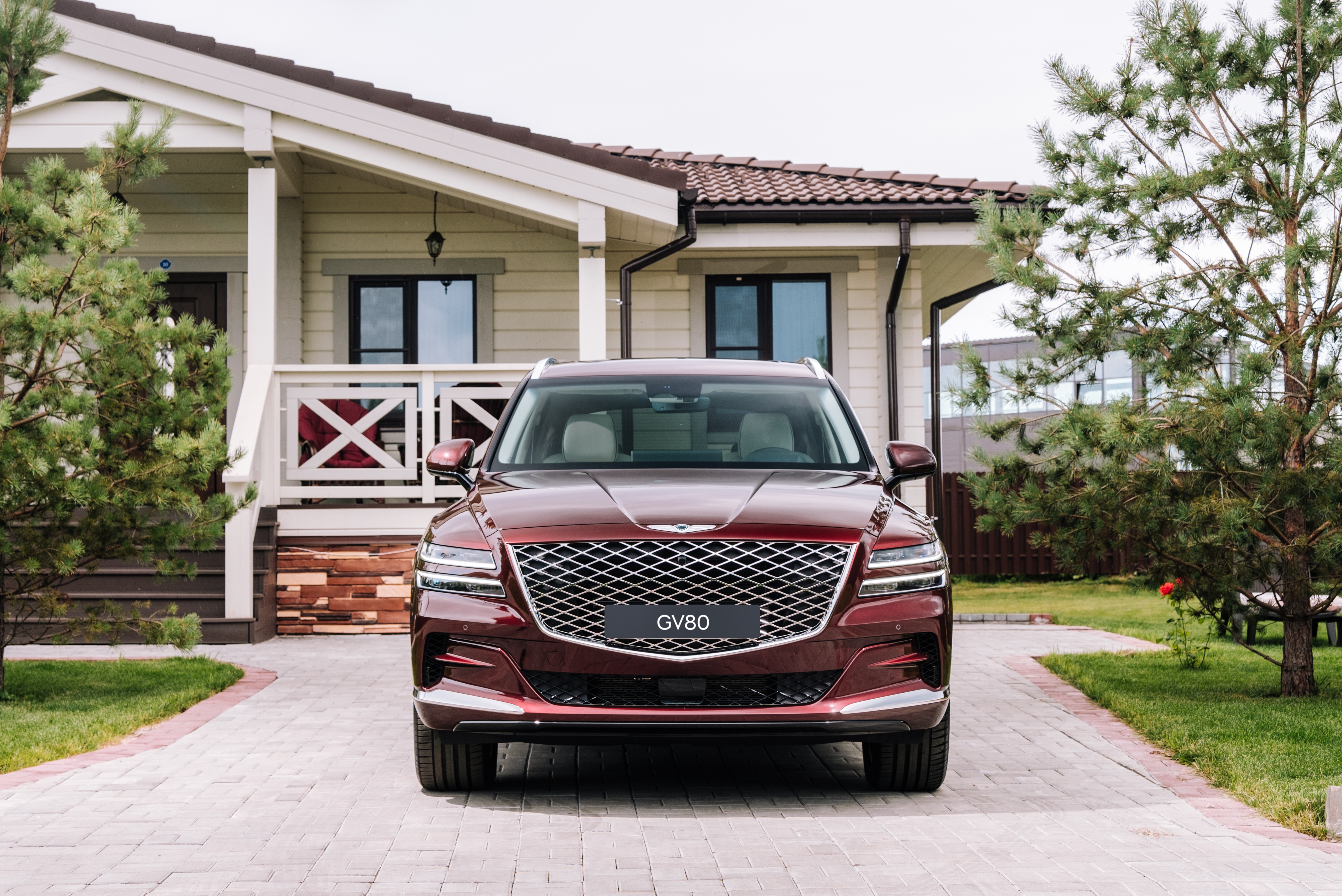 Genesis GV80 SUV parked in front of a house HD Wallpaper