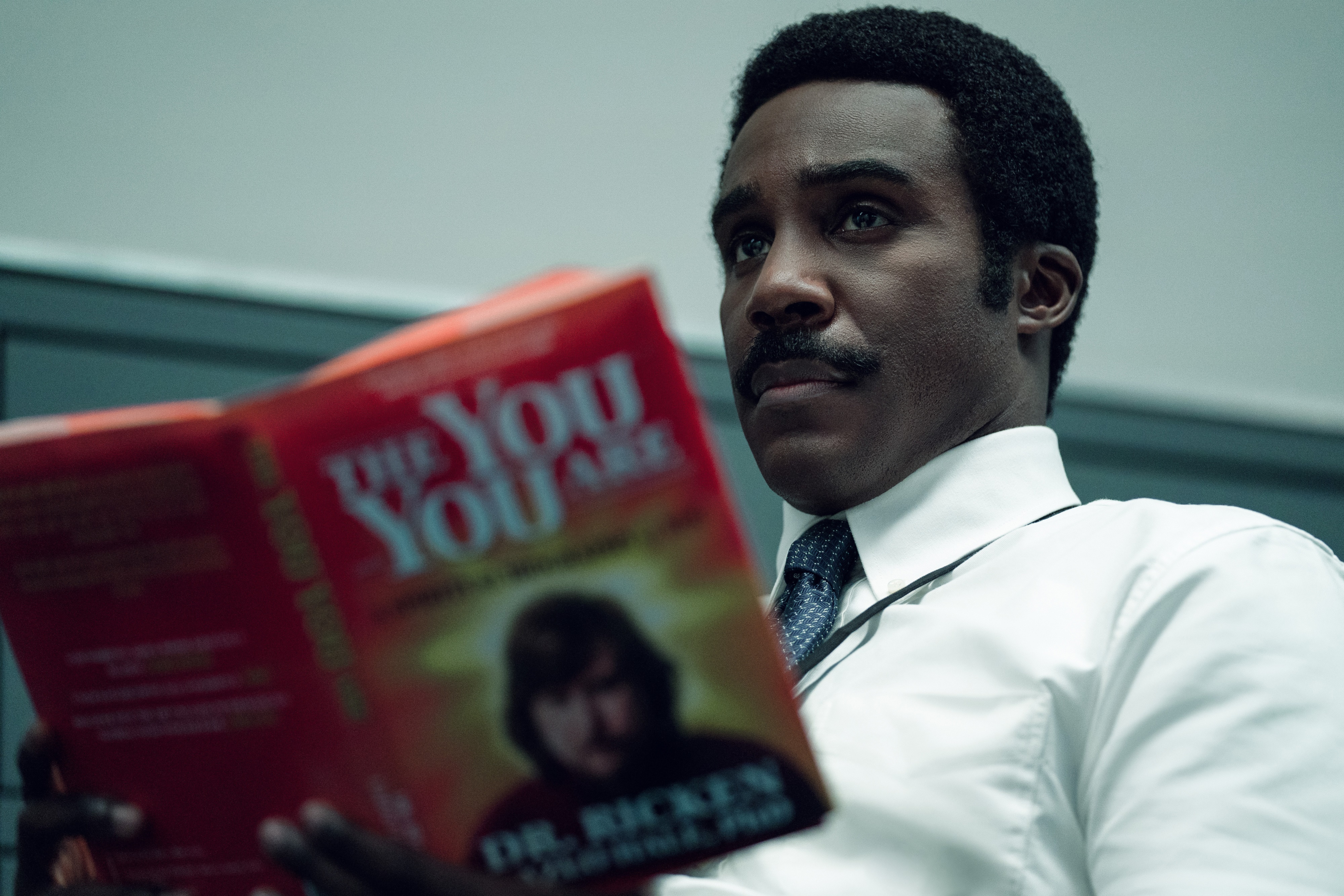 Milchick from Severance reading a book HD Wallpaper