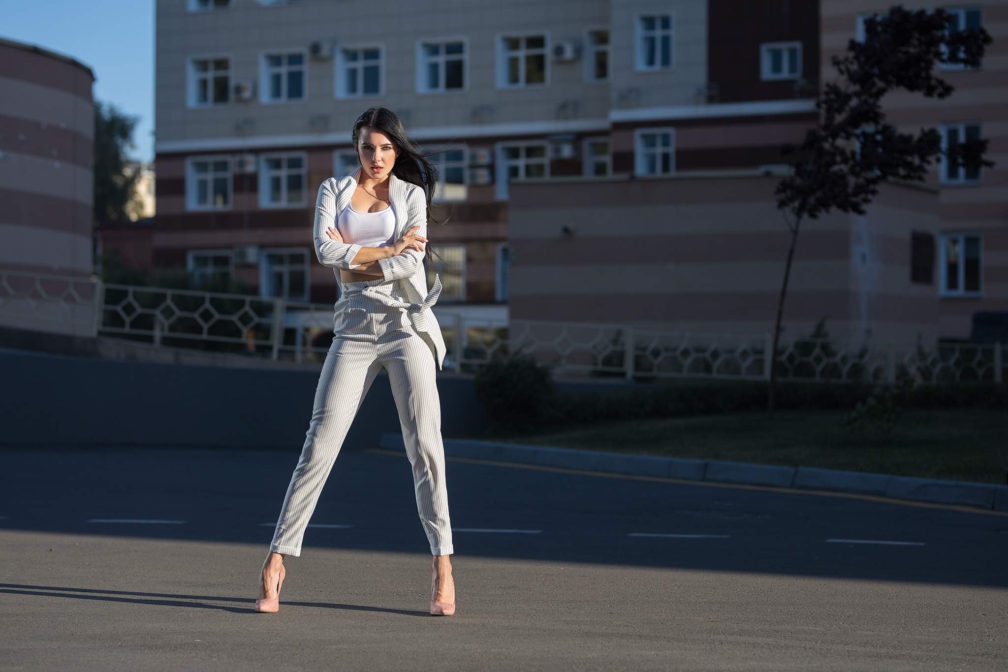 Woman in a stylish suit standing outdoors HD Wallpaper