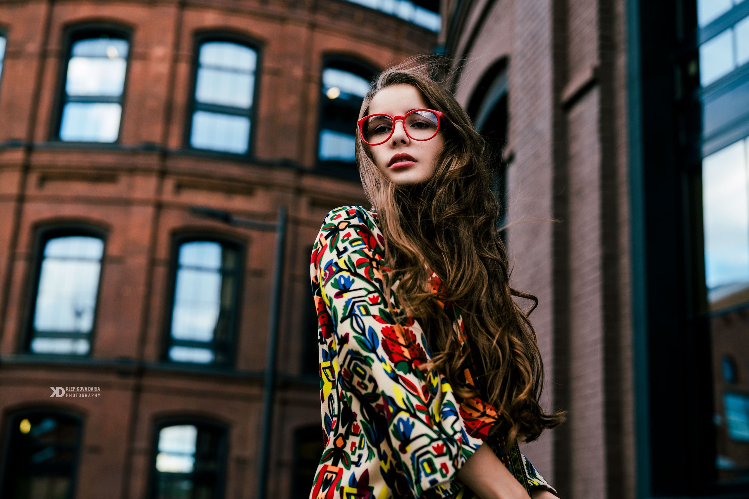Young woman with long brown hair and red glasses HD Wallpaper