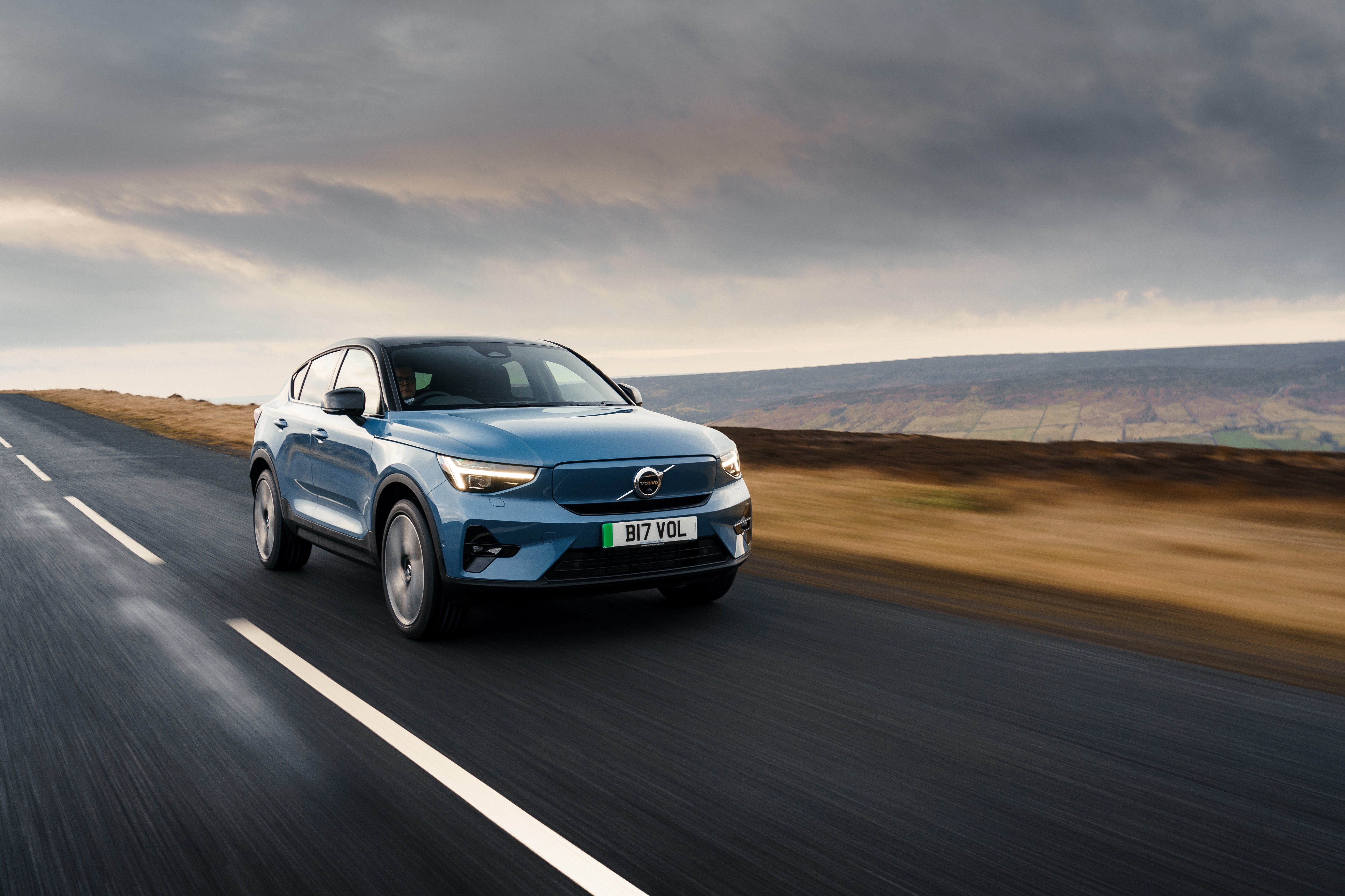Blue Volvo C40 4K driving on a road HD Wallpaper
