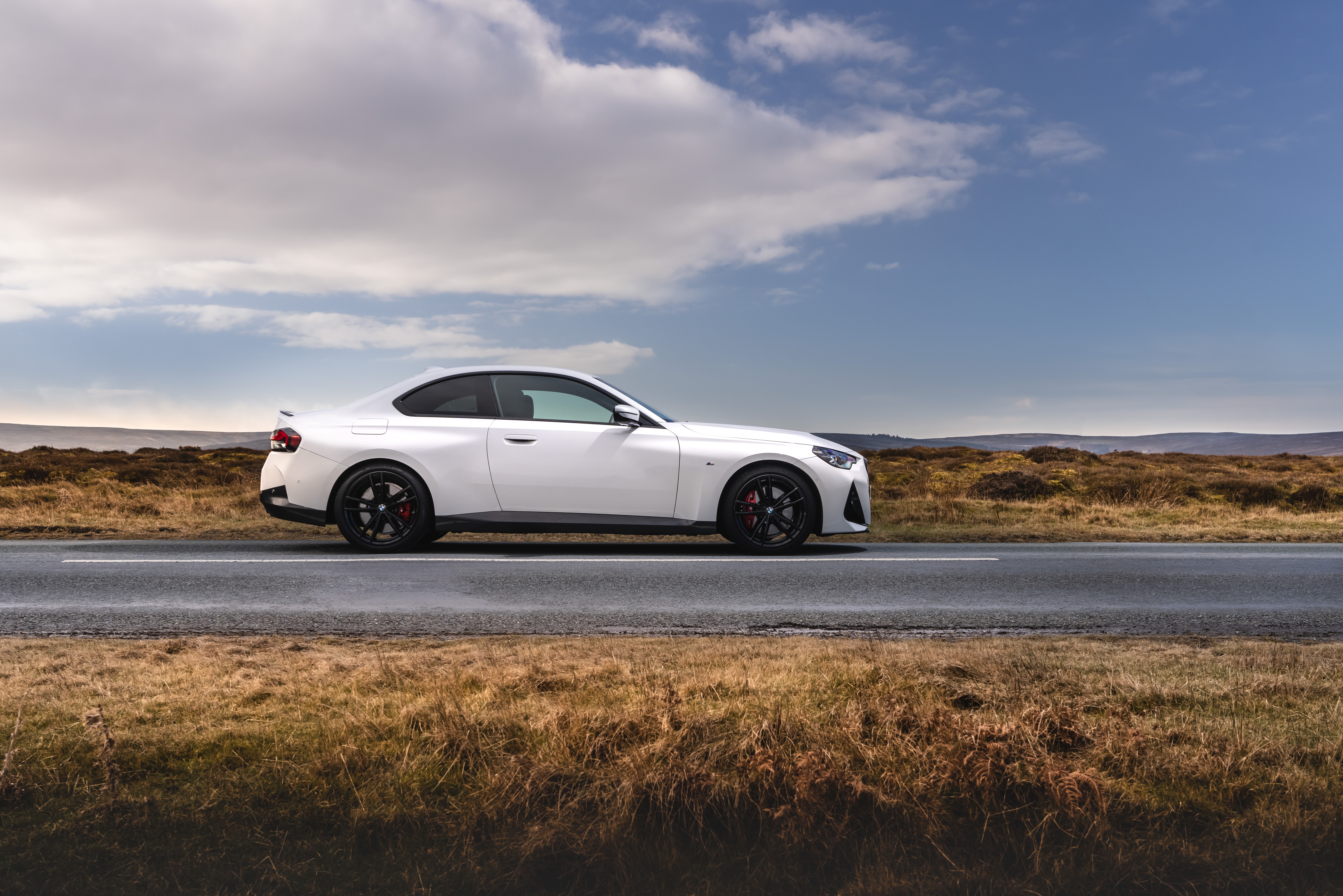 White BMW 220i Coupé M Sport on a road HD Wallpaper