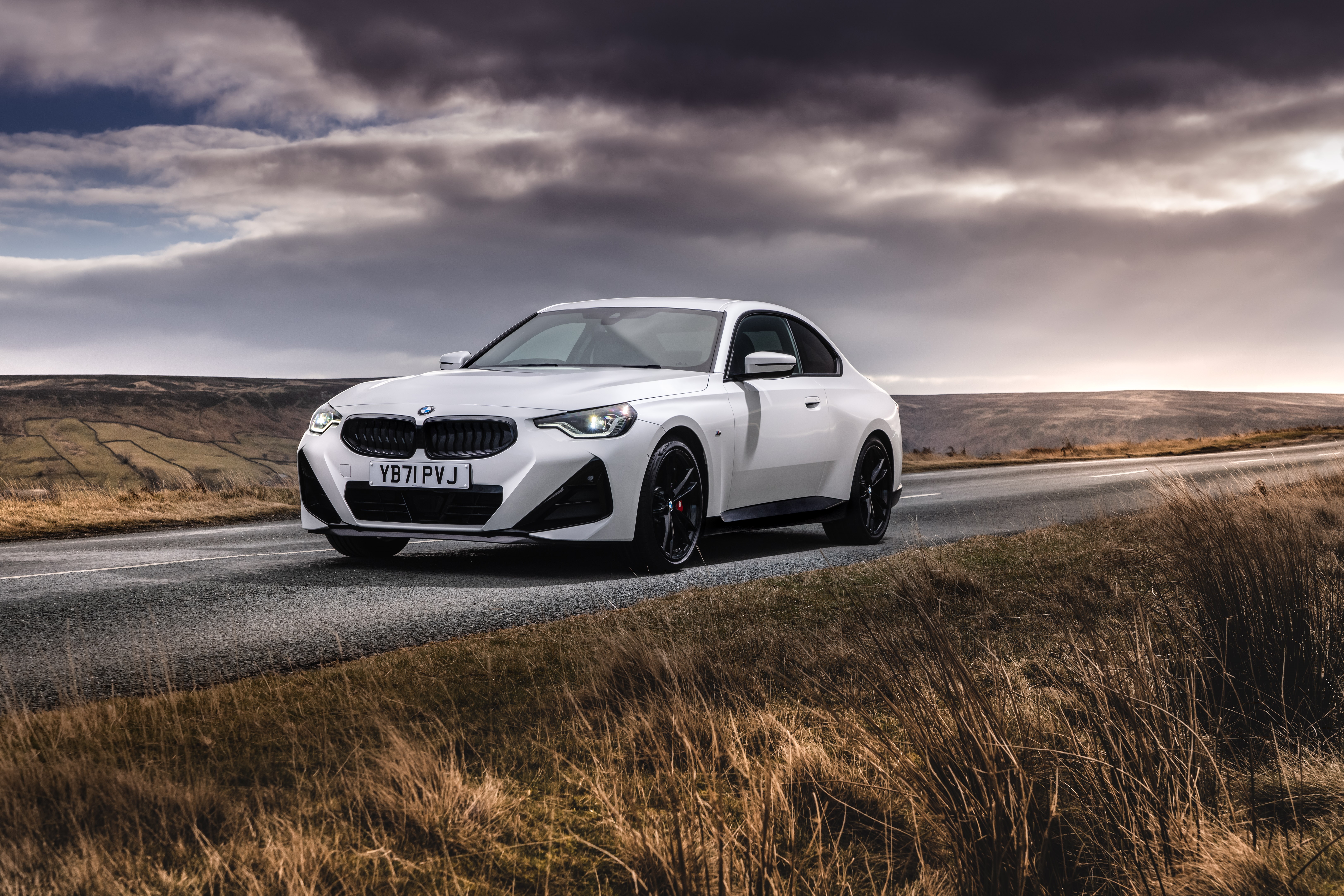 White BMW 220i Coupé M Sport on a road HD Wallpaper