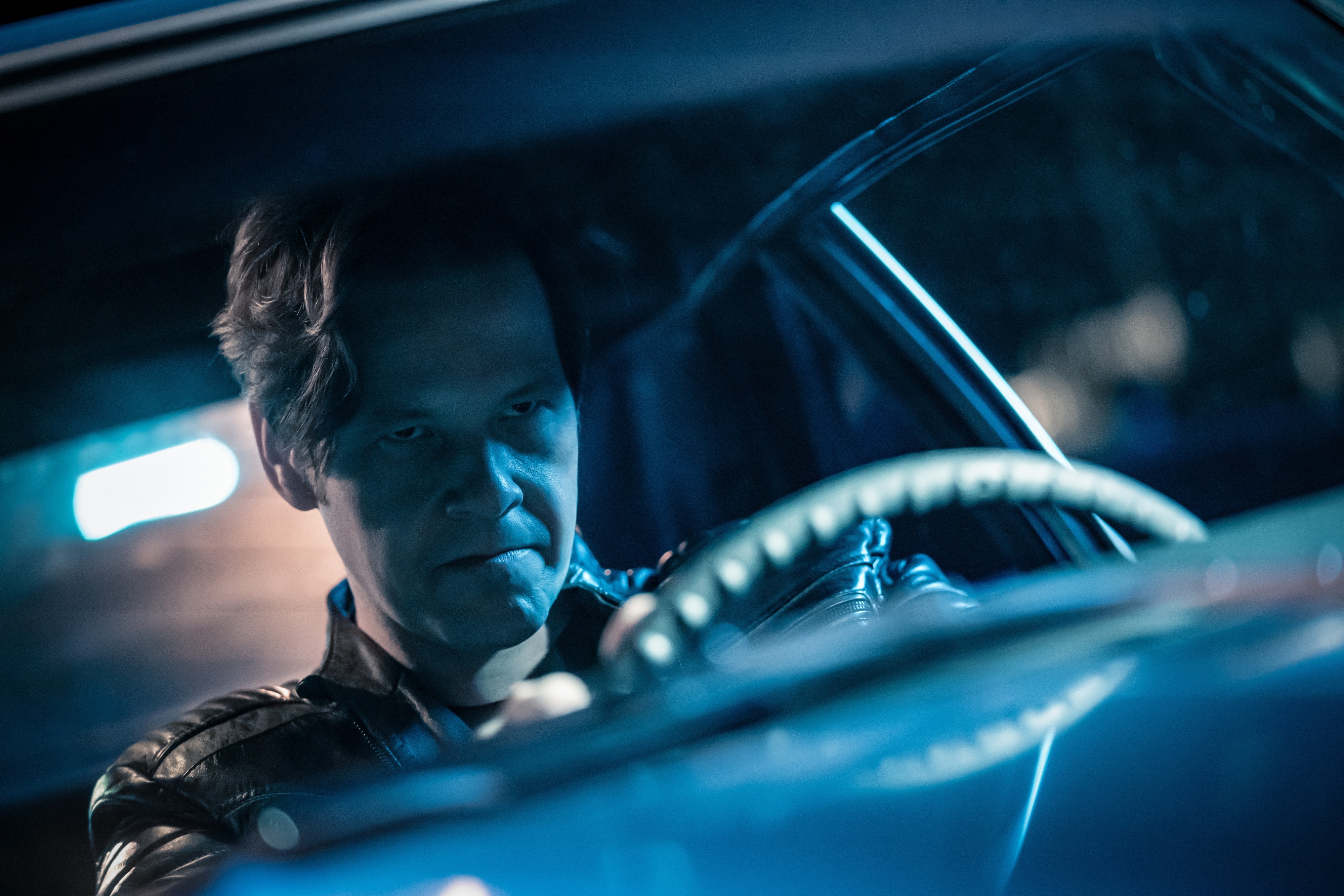 Man driving a car at night HD Wallpaper