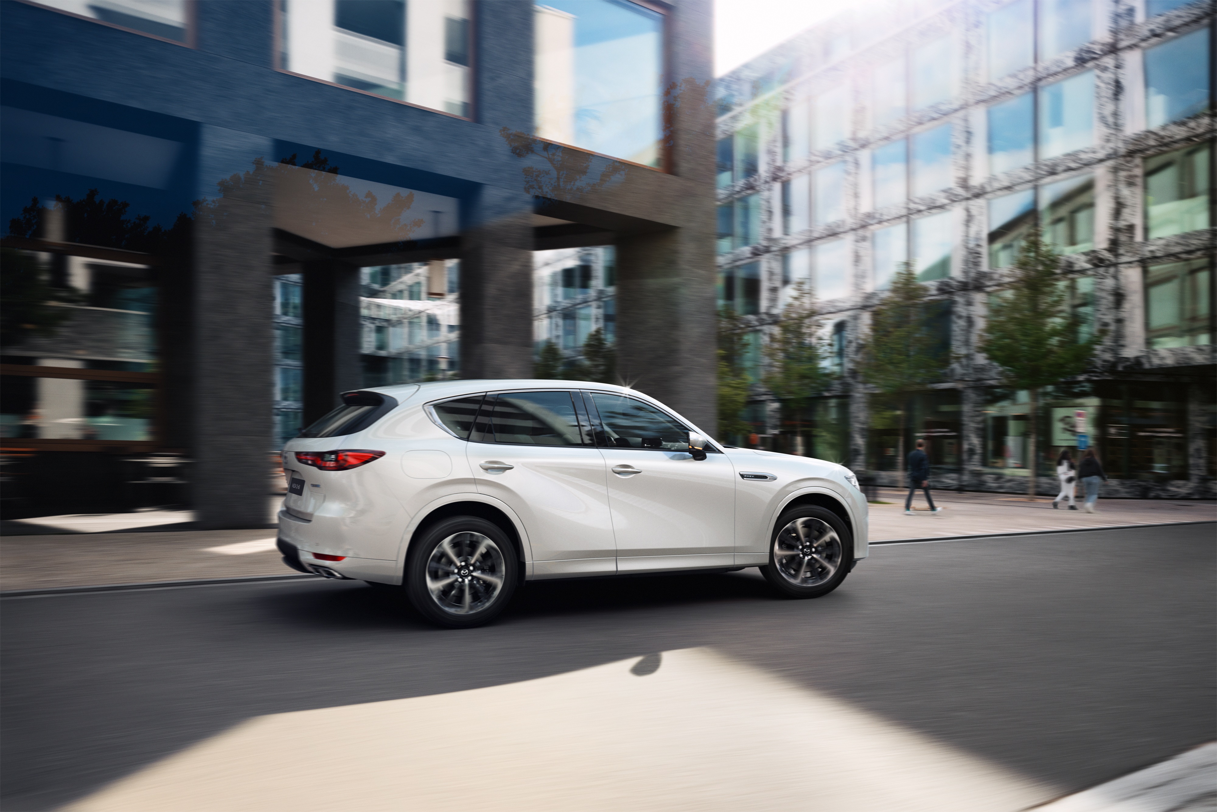 White Mazda CX-60 SUV driving on city street HD Wallpaper