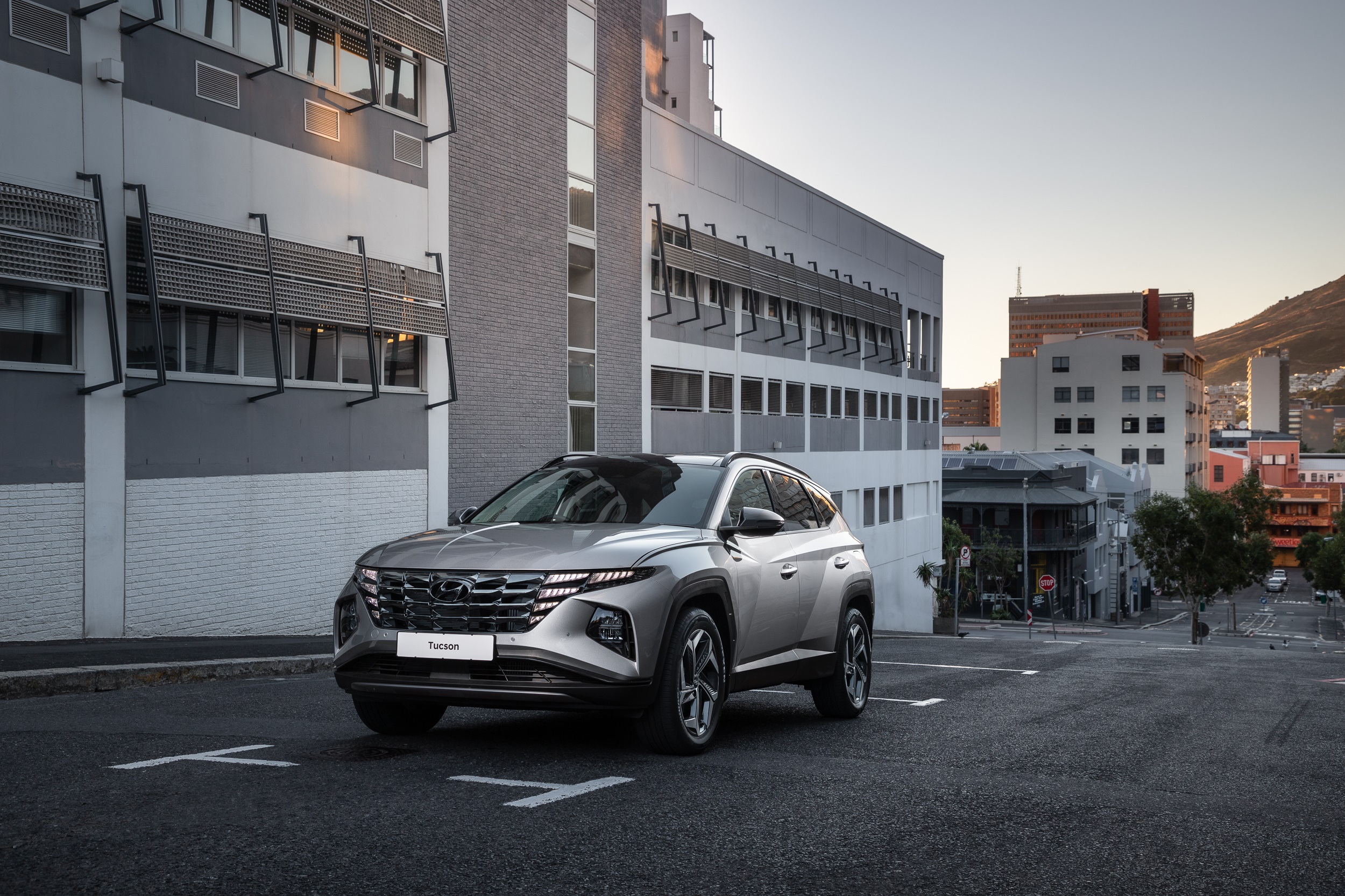 Silver Hyundai Tucson SUV parked on city street HD Wallpaper