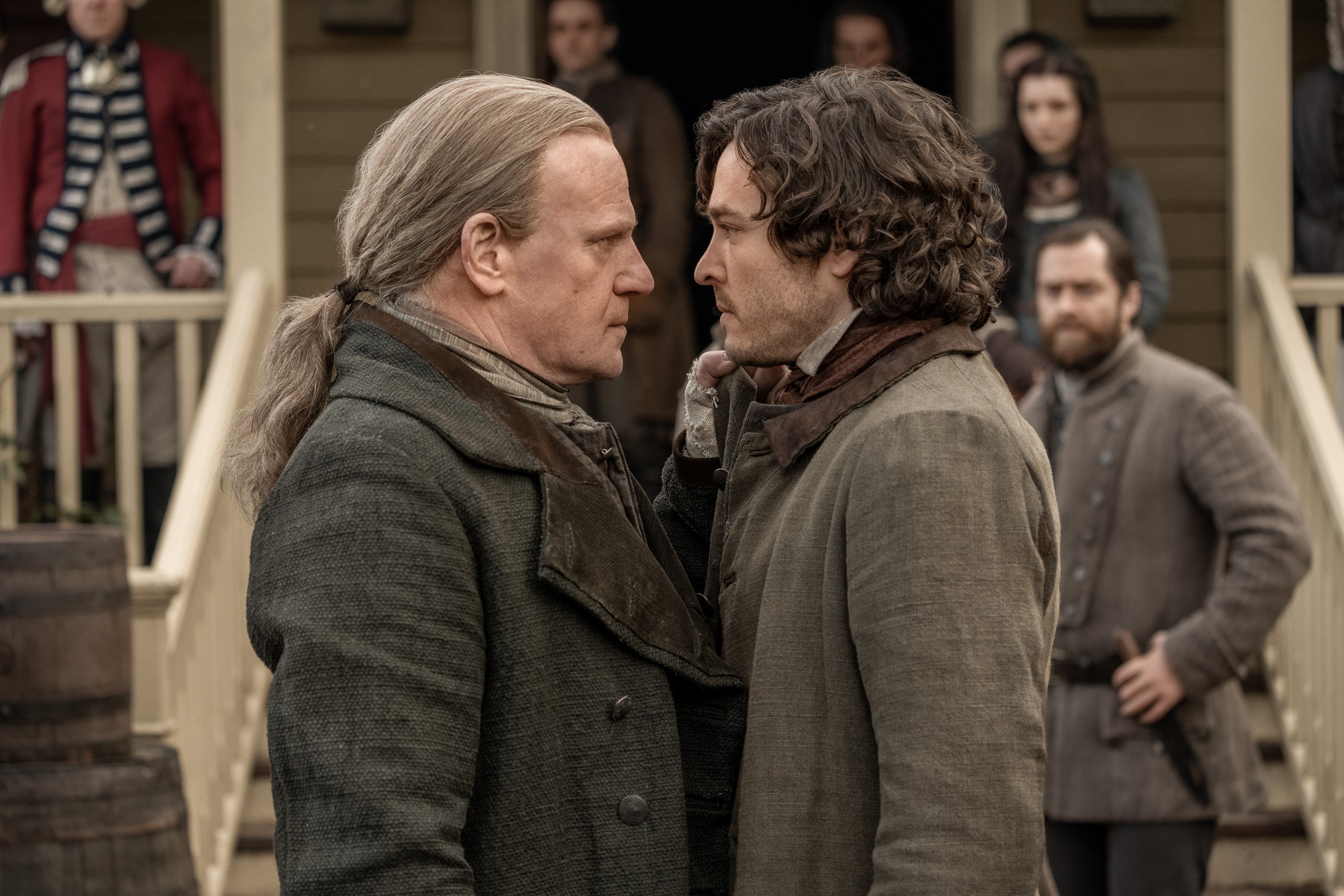 Two men confront each other in front of a building HD Wallpaper